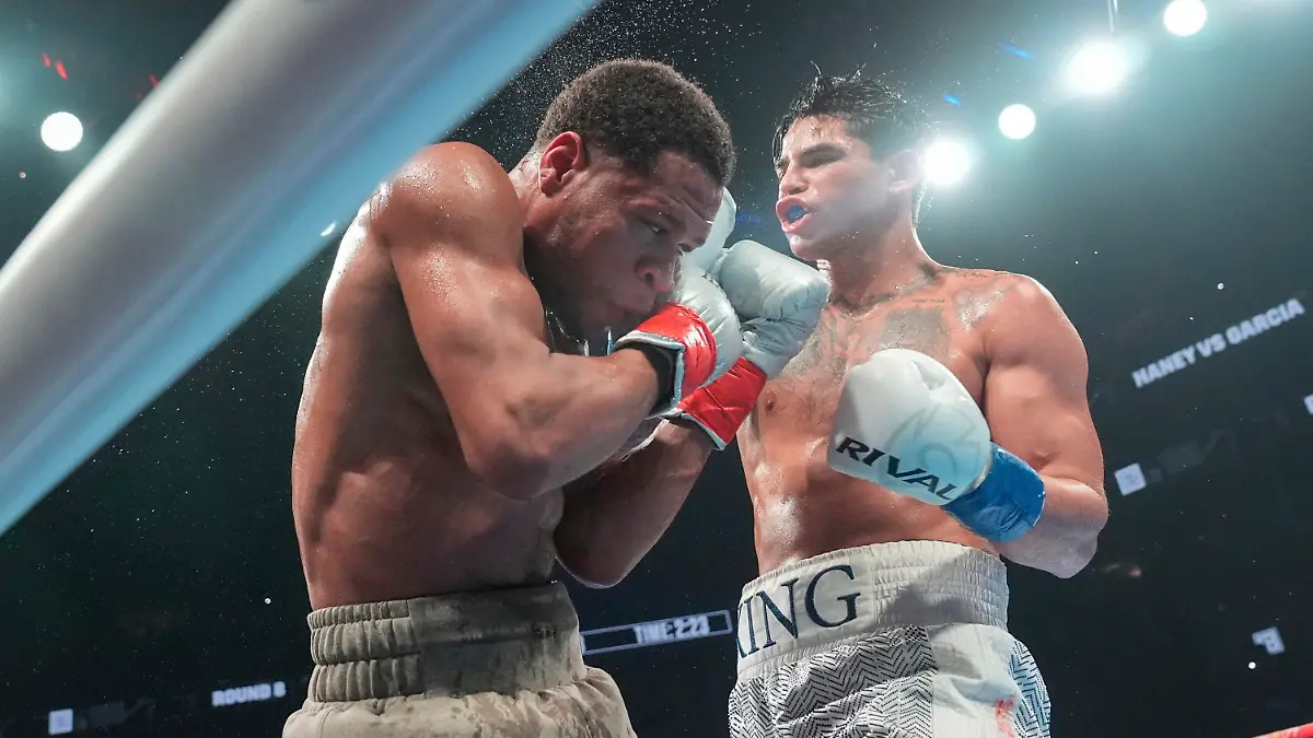 Ryan Garcia, right, punches Devin Haney during the eighth round of a super lightweight boxing match early Sunday, April 21, 2024, in New York. Garcia won the fight. (AP Photo/Frank Franklin II)