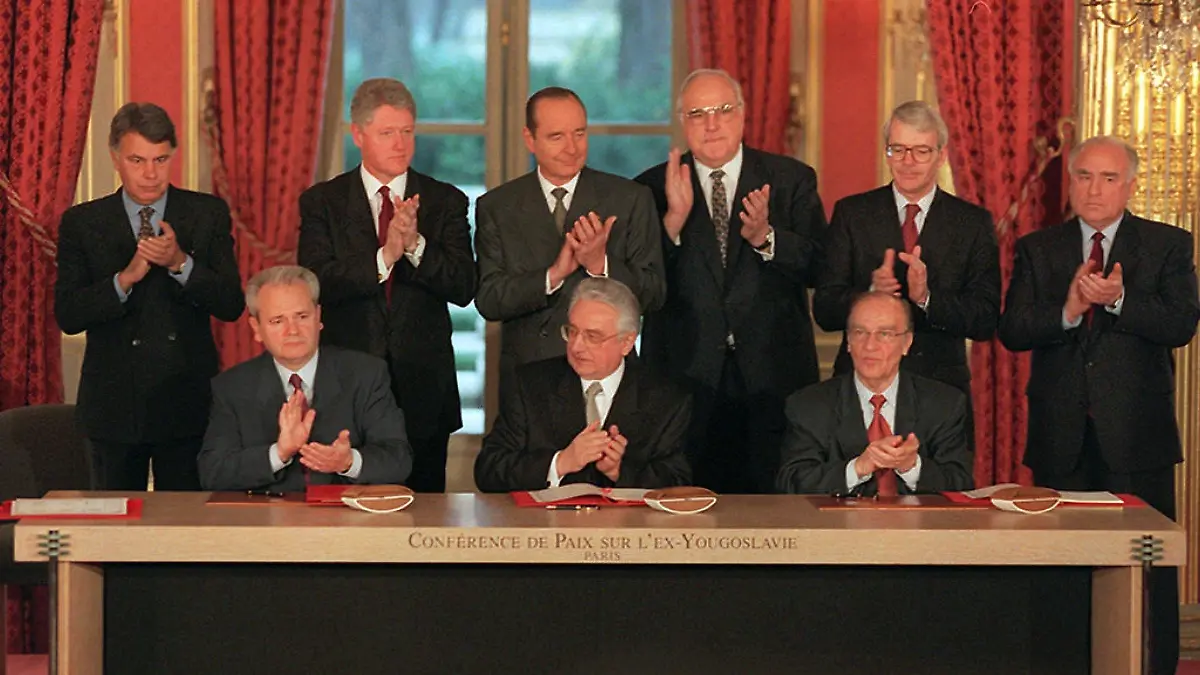 From left background, Spanish Prime Minister Felipe Gonzalez, US President Bill Clinton, French President Jacques Chirac, German Chancellor Helmut Kohl, British Prime Minister John Major and Russian Prime Minister Victor Chernomyrdin, from left front Serbian President Slobodan Milosevic, Croatian President Franjo Tudjman and Bosnian President Alija Izetbegovic applaud after signing of the peace agreement on Bosnia at the Elysee Palace in Paris 14 December. The accord was reached in Dayton 21 November ending over four years of war in former Yugoslavia.