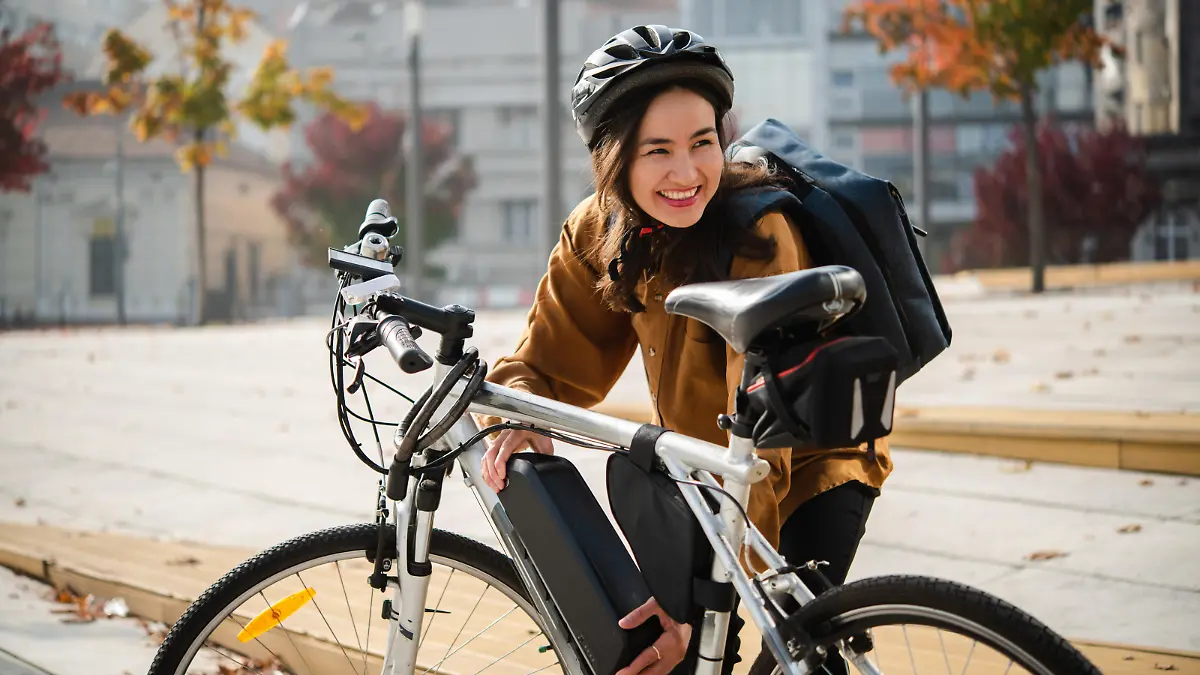 Portrait of a beautiful Asian woman preparing to go to work on an electric bike