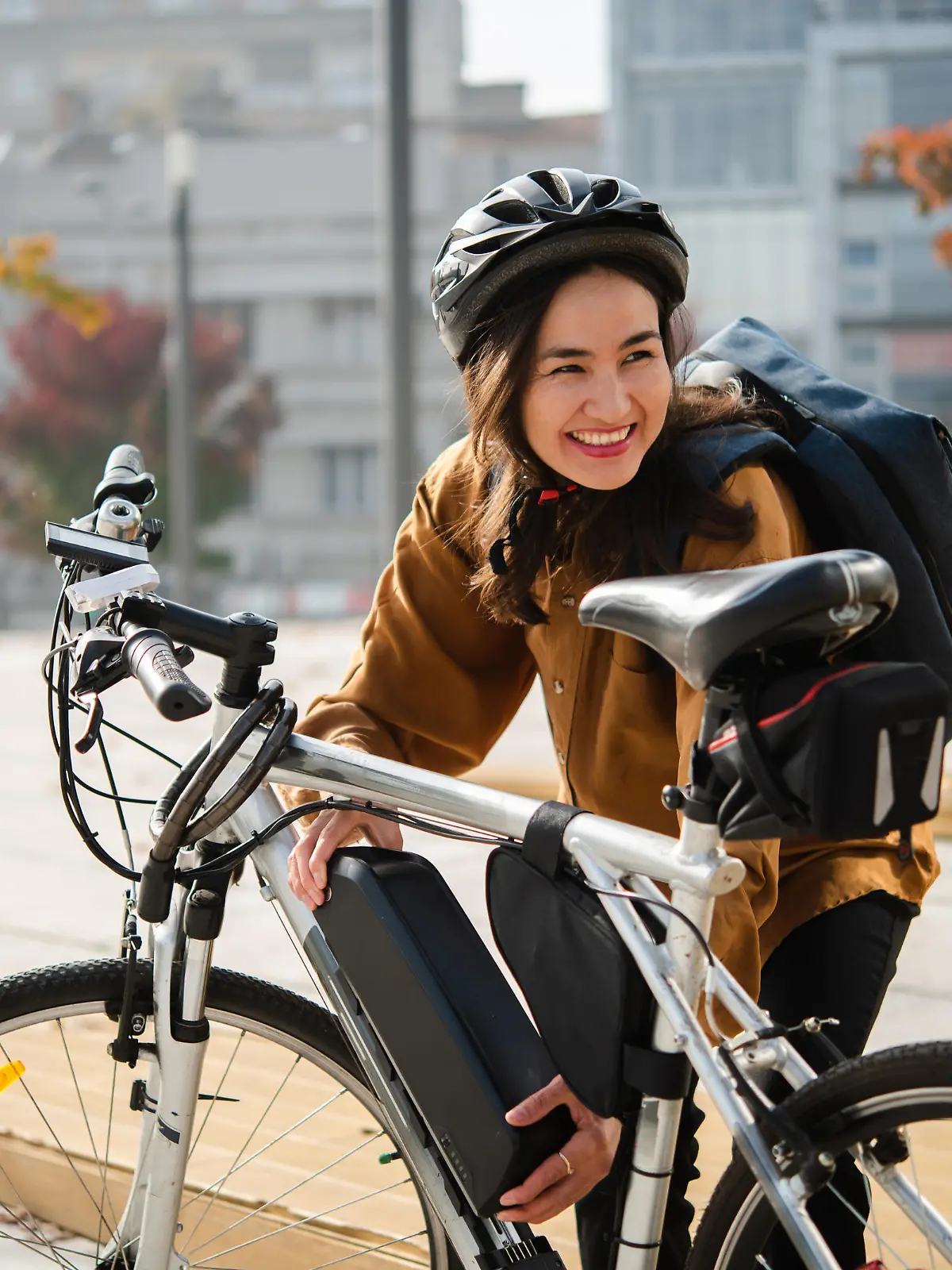 Portrait of a beautiful Asian woman preparing to go to work on an electric bike