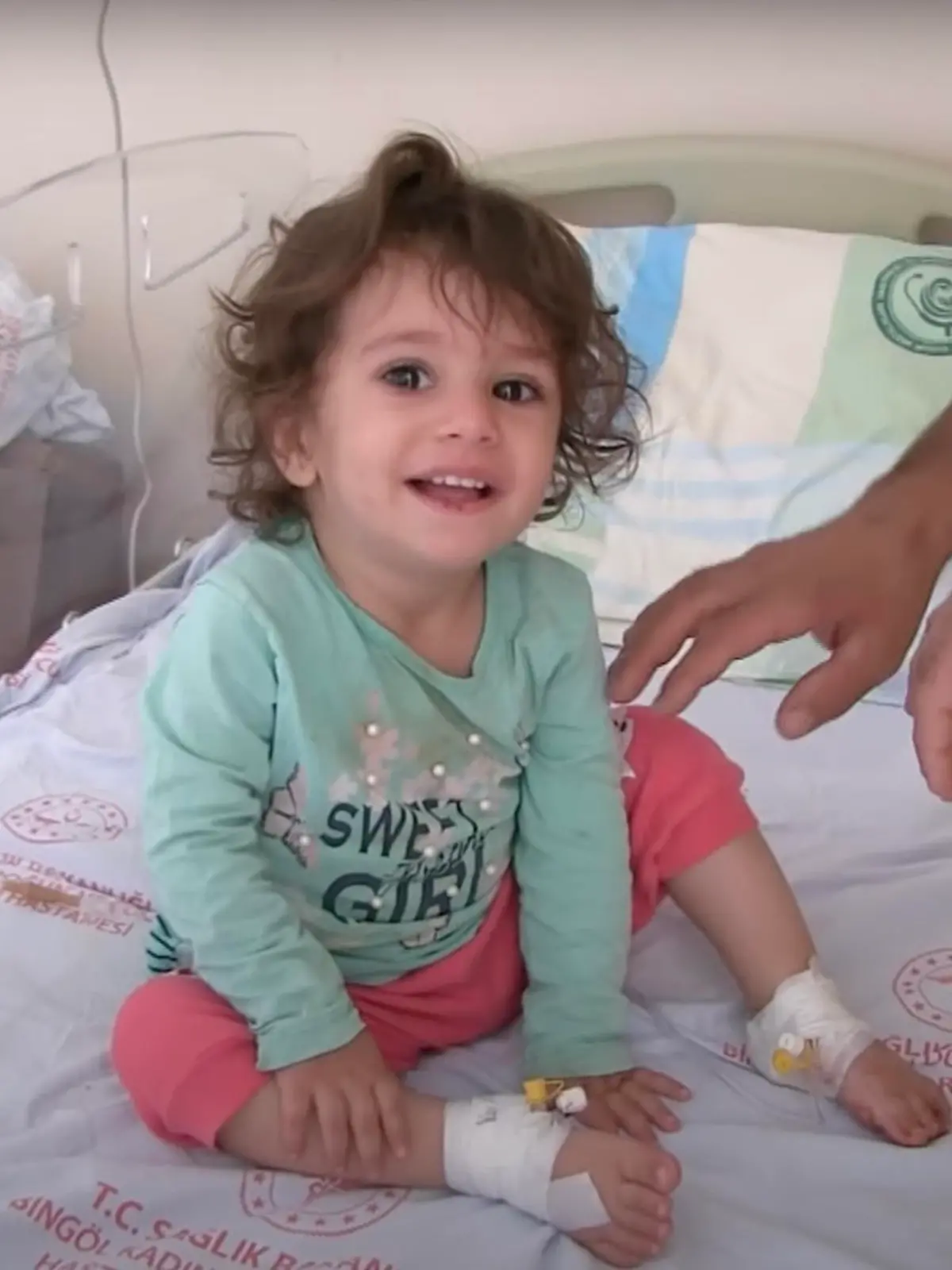 A girl, 2, sits on a hospital bed in Bingol, Turkey, in undated video. She allegedly bit a snake that bit her. (Newsflash)