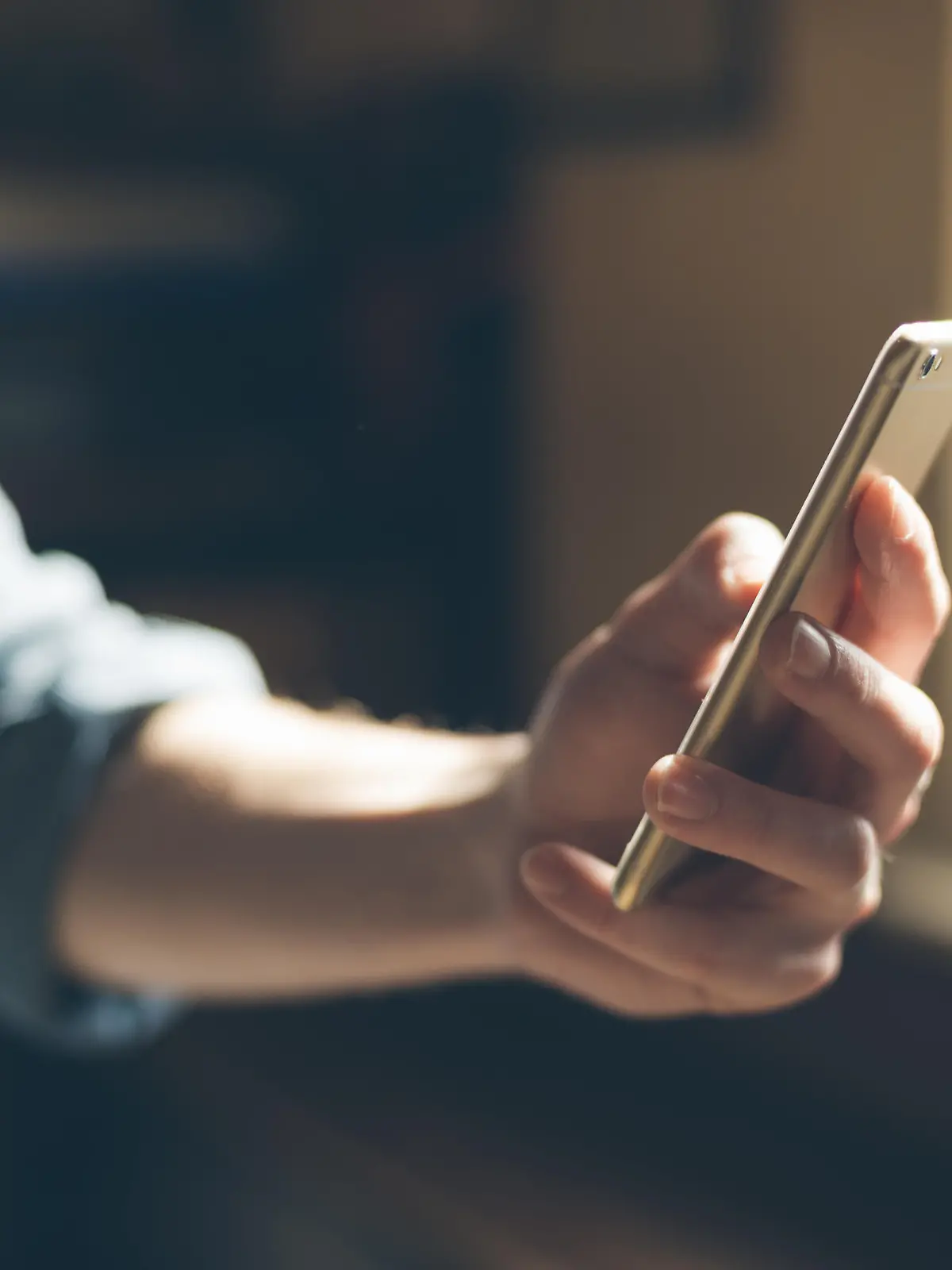 Hipster using a touch screen smart phone hands close up, vintage colors