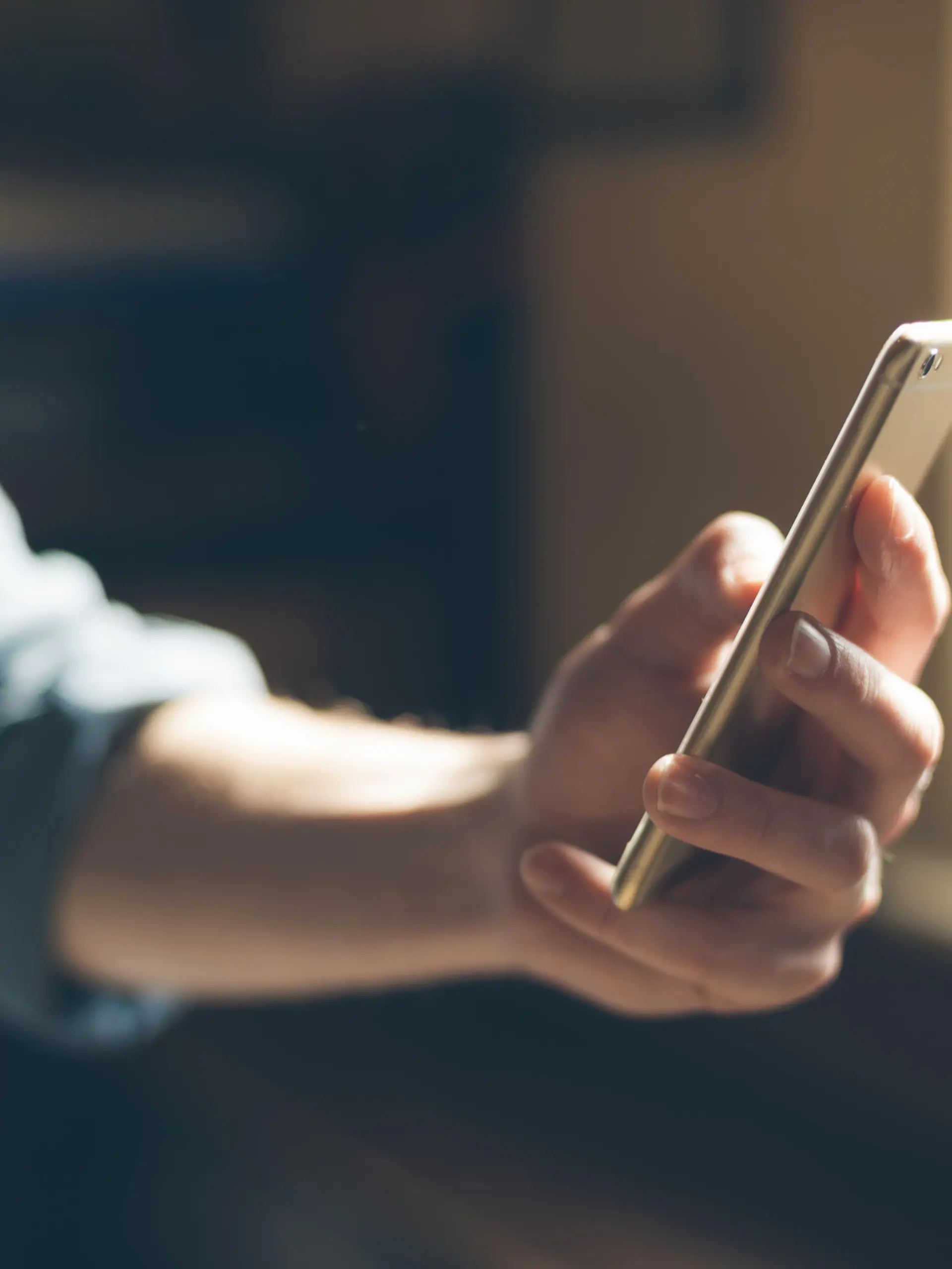 Hipster using a touch screen smart phone hands close up, vintage colors