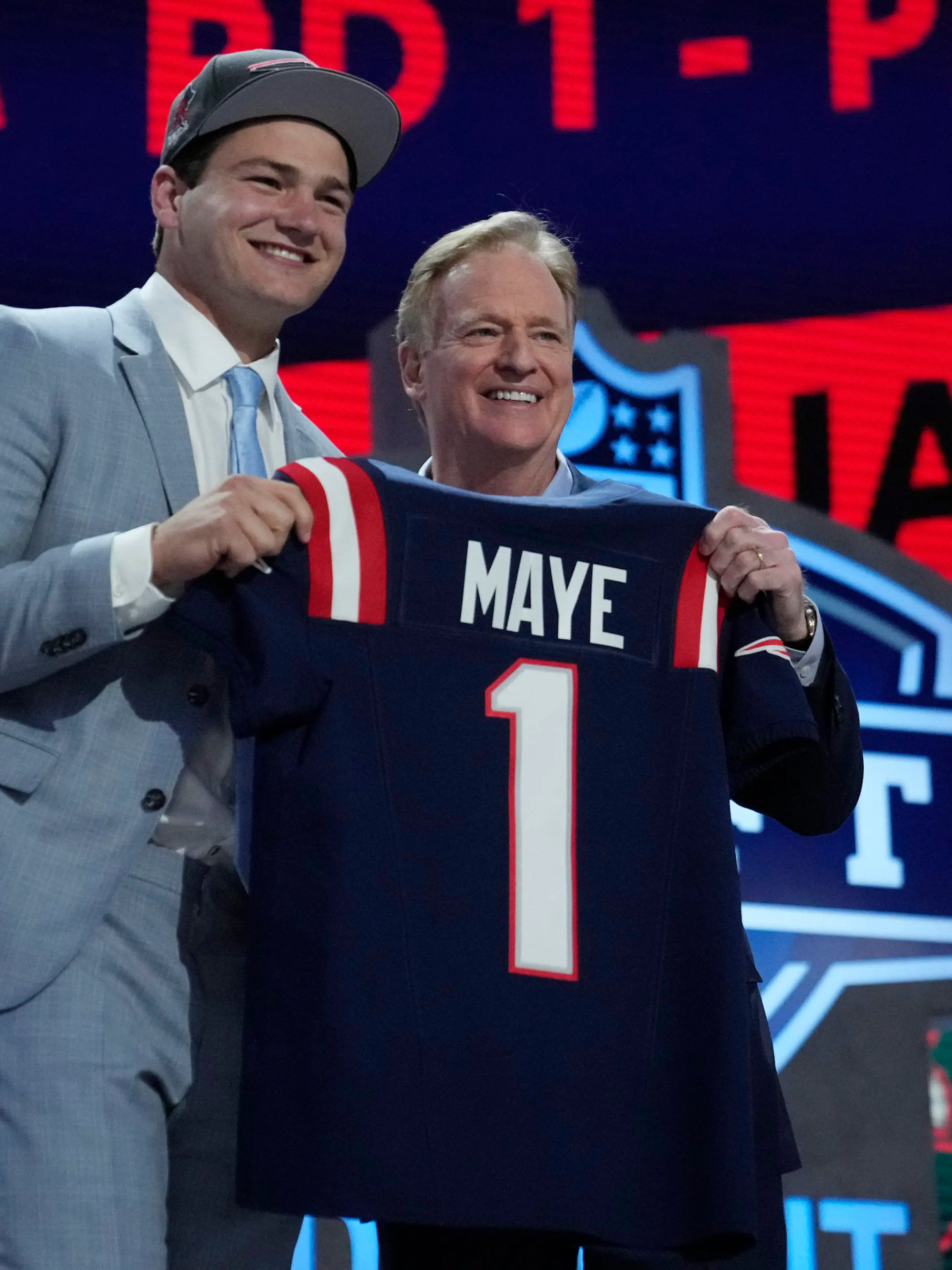 North Carolina quarterback Drake Maye poses with NFL commissioner Roger Goodell after being chosen by the New England Patriots with the third overall pick during the first round of the NFL football draft, Thursday, April 25, 2024, in Detroit. (AP Photo/Jeff Roberson)