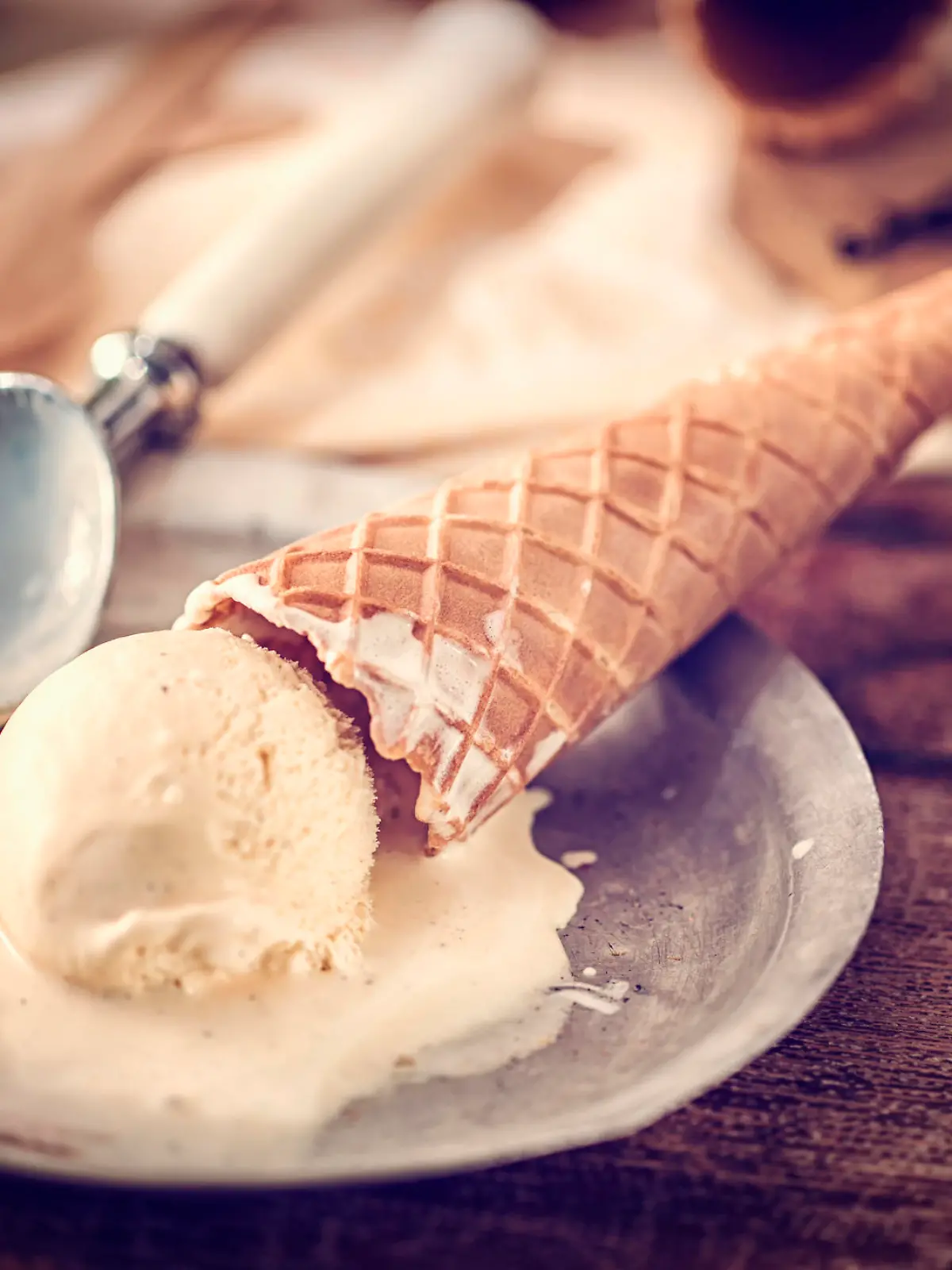 Homemade vanilla ice cream in a cone. This creamy delicious ice cream is a perfect treat on a sunny day.