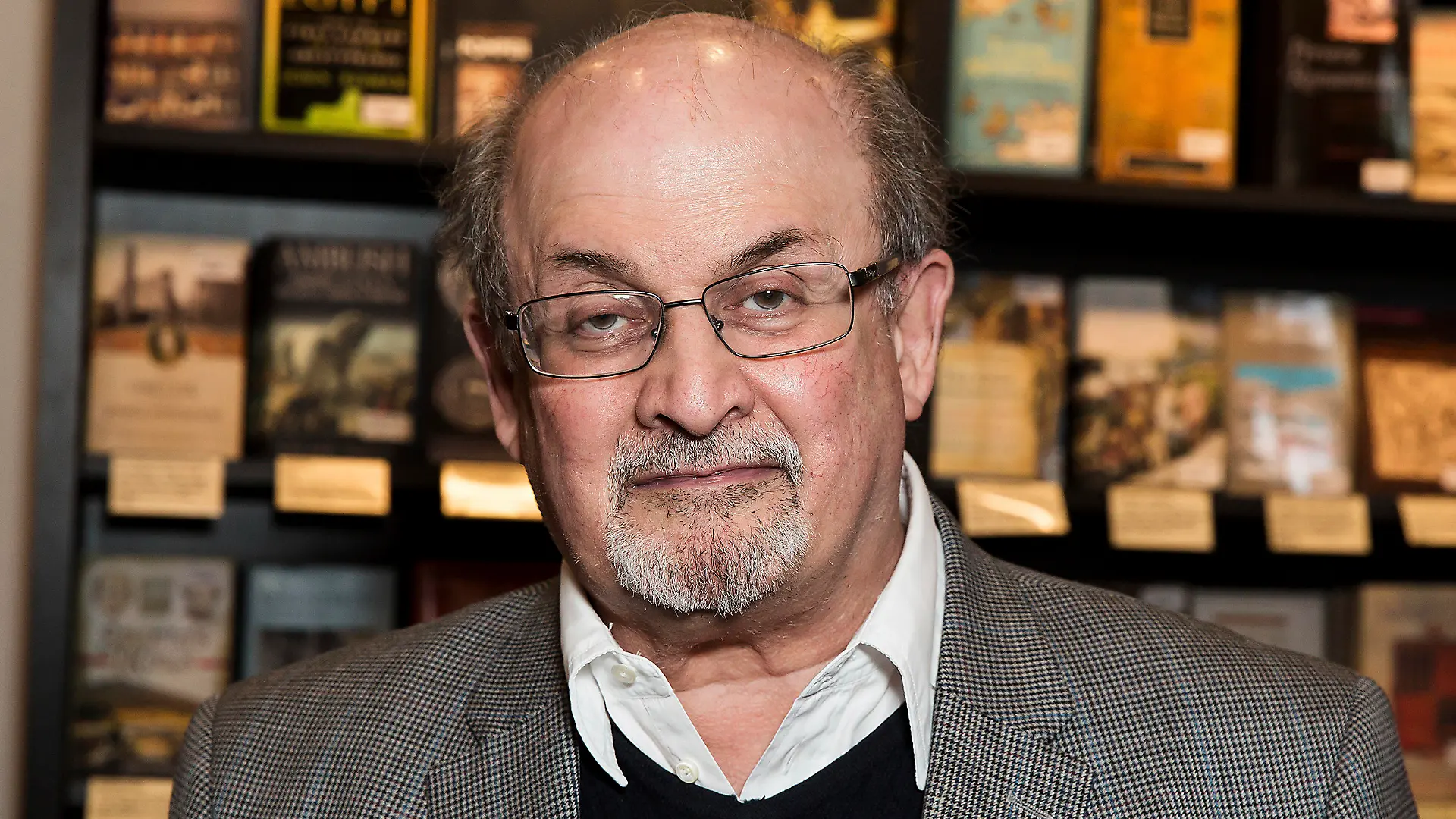 FILE - Author Salman Rushdie appears at a signing for his book "Home" in London on June 6, 2017. Rushdie has been attacked while giving a lecture in western New York. An Associated Press reporter witnessed a man storm the stage Friday at the Chautauqua Institution and begin punching or stabbing Rushdie as he was being introduced. (Photo by Grant Pollard/Invision/AP, File)