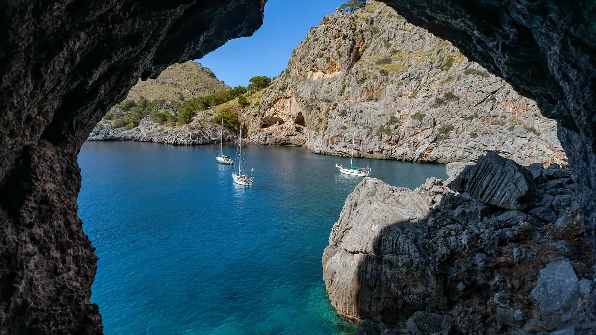 Cruise ships moored in the bay, Sa Calobra, Escorca, Paraje Natural de la Serra de Tramuntana, Balearic Islands Mallorca Spain. Travel agency vacation concept.