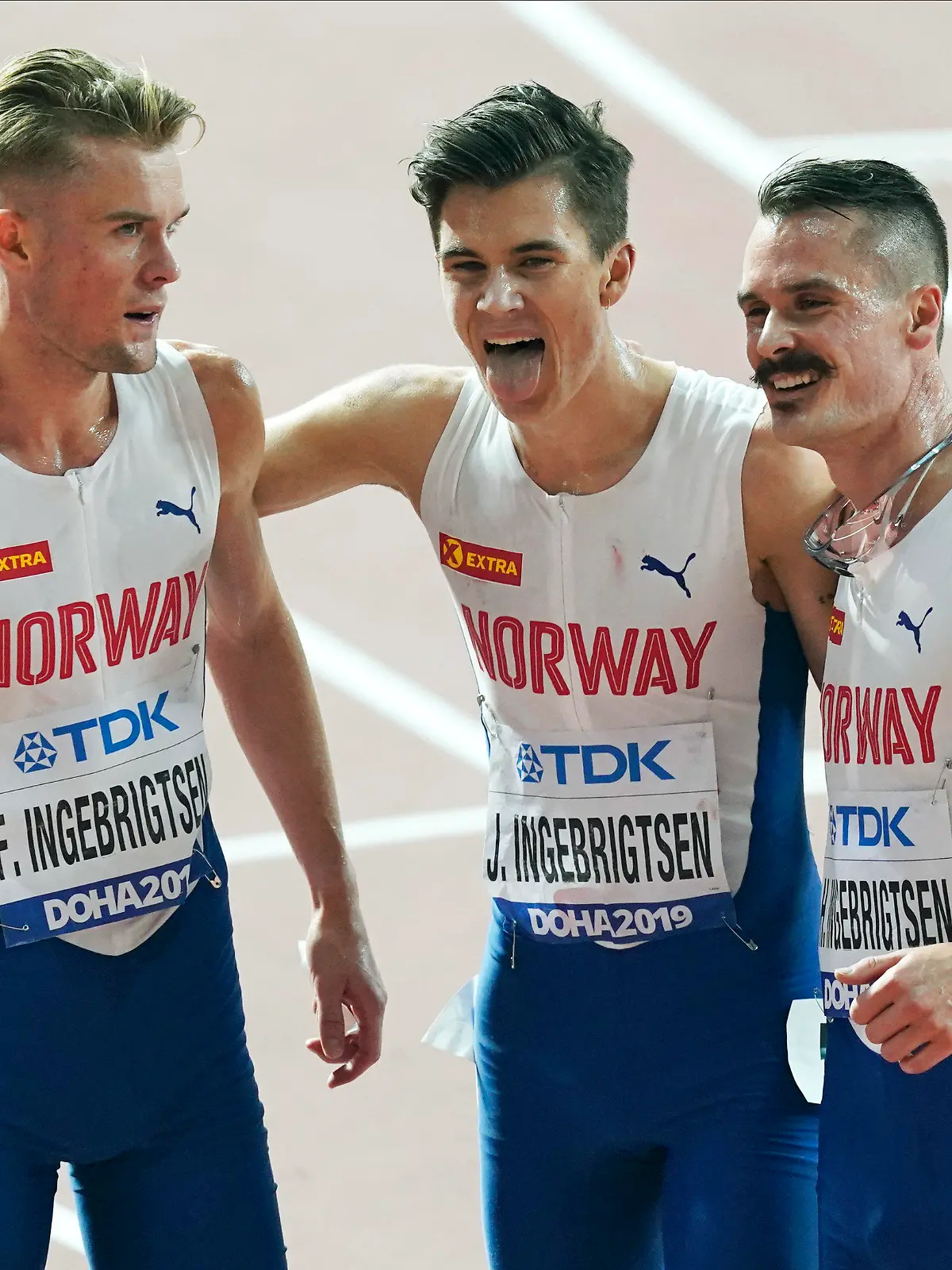 FILE - From left, brothers Filip Ingebrigtsen, Jakob Ingebrigtsen, and Henrik Ingebrigtsen, of Norway, react after competing in the men's 5000 meter final at the World Athletics Championships in Doha, Qatar, on Sept. 30, 2019. Father of Ingebrigtsen brothers is charged with abuse of “one of his minor children,” lawyer says. (AP Photo/Nick Didlick, File)