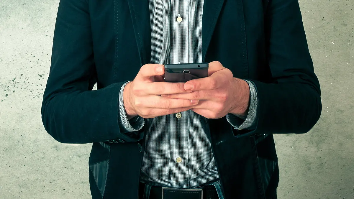 Handsome young bearded man with phone