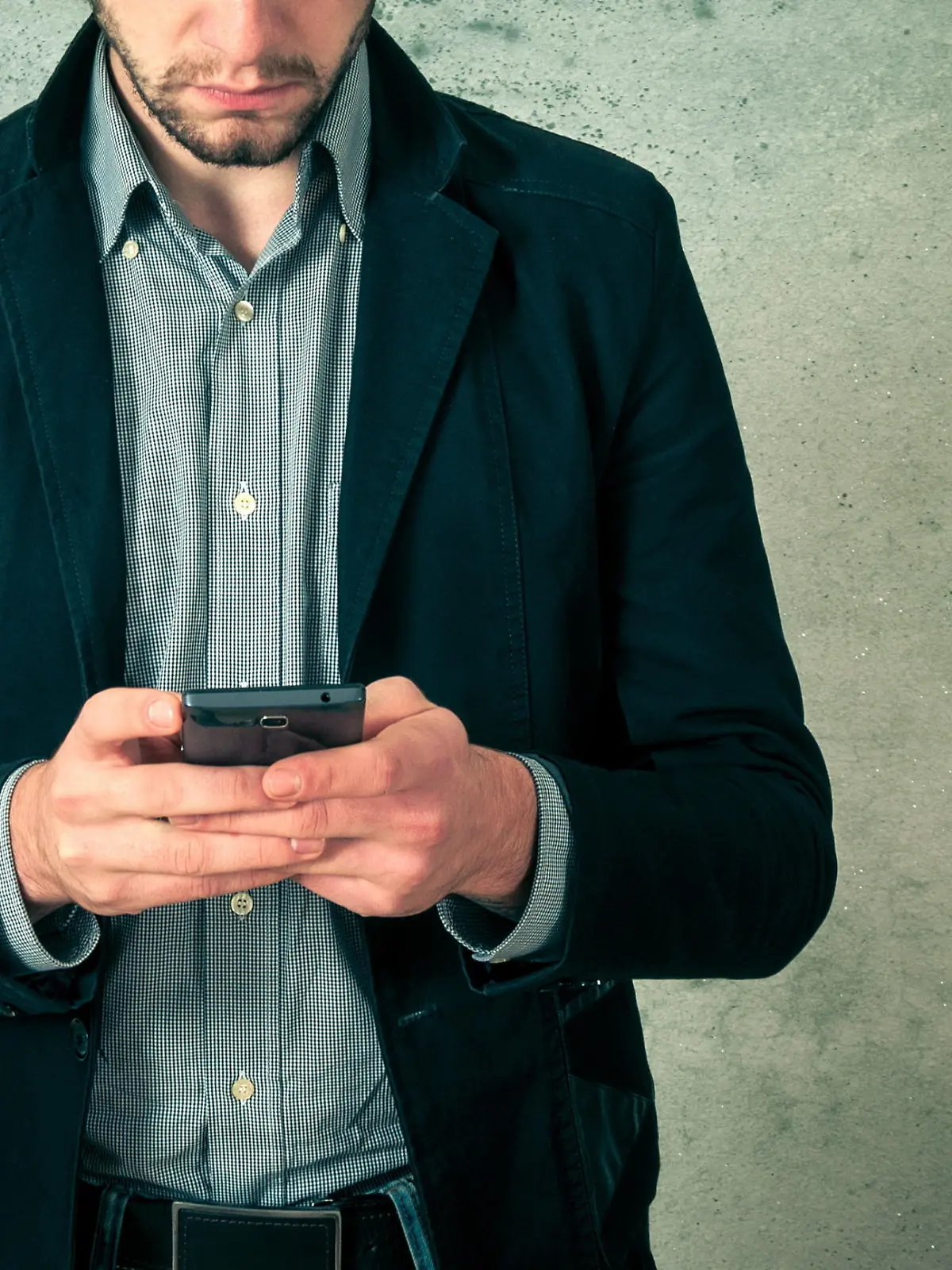 Handsome young bearded man with phone