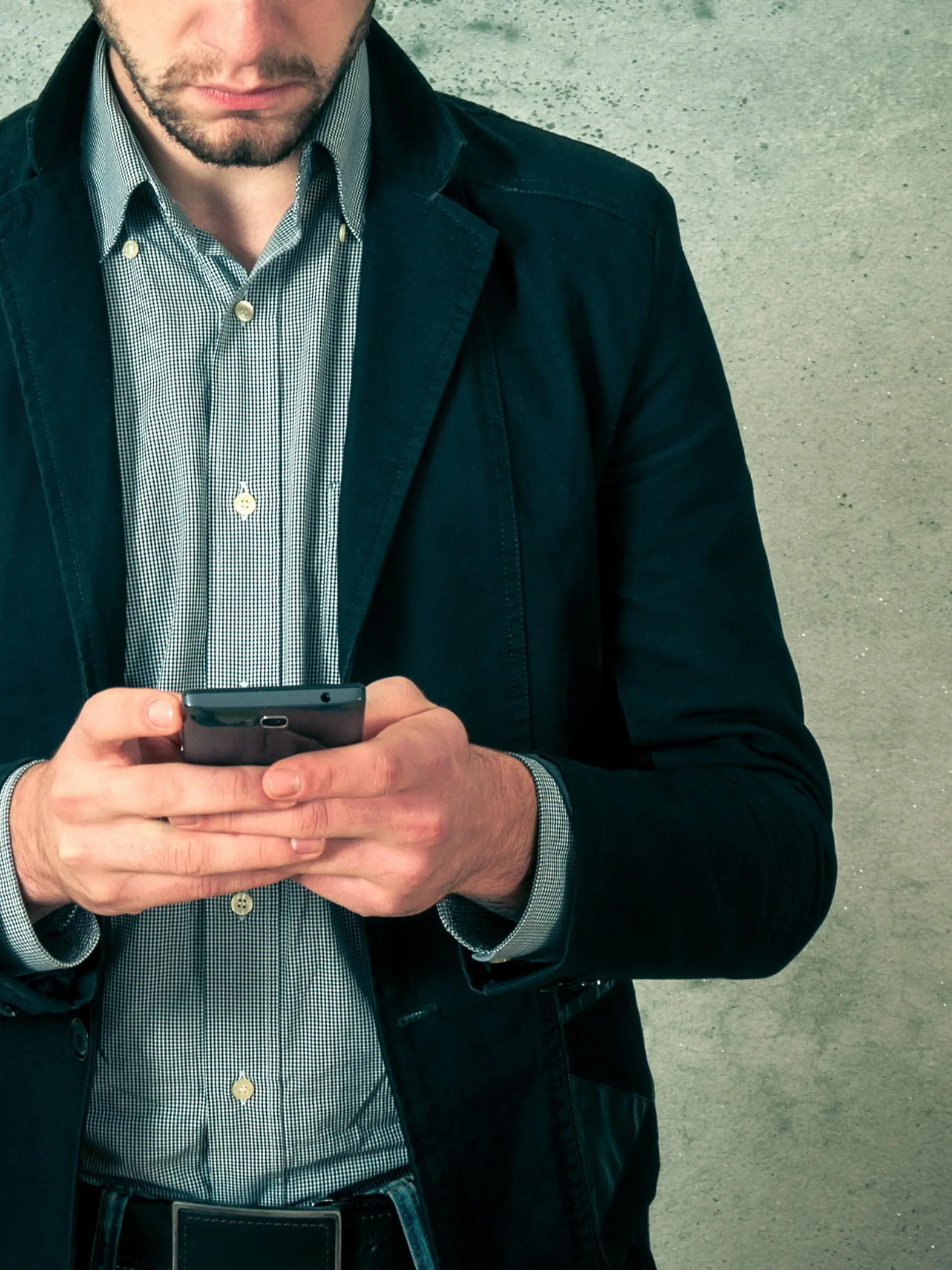 Handsome young bearded man with phone