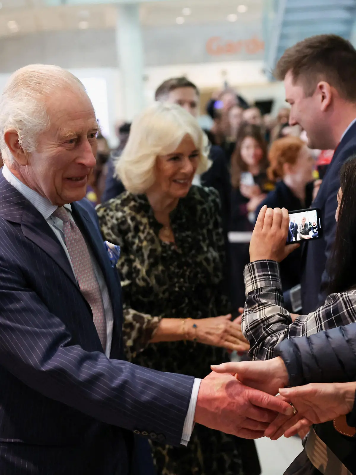 Britain's King Charles and Queen Camilla meet staff members as they arrive to visit to the University College Hospital Macmillan Cancer Centre in London, Britain, April 30, 2024. REUTERS/Suzanne Plunkett/Pool