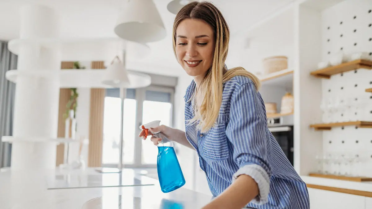 Young woman cleaning her house