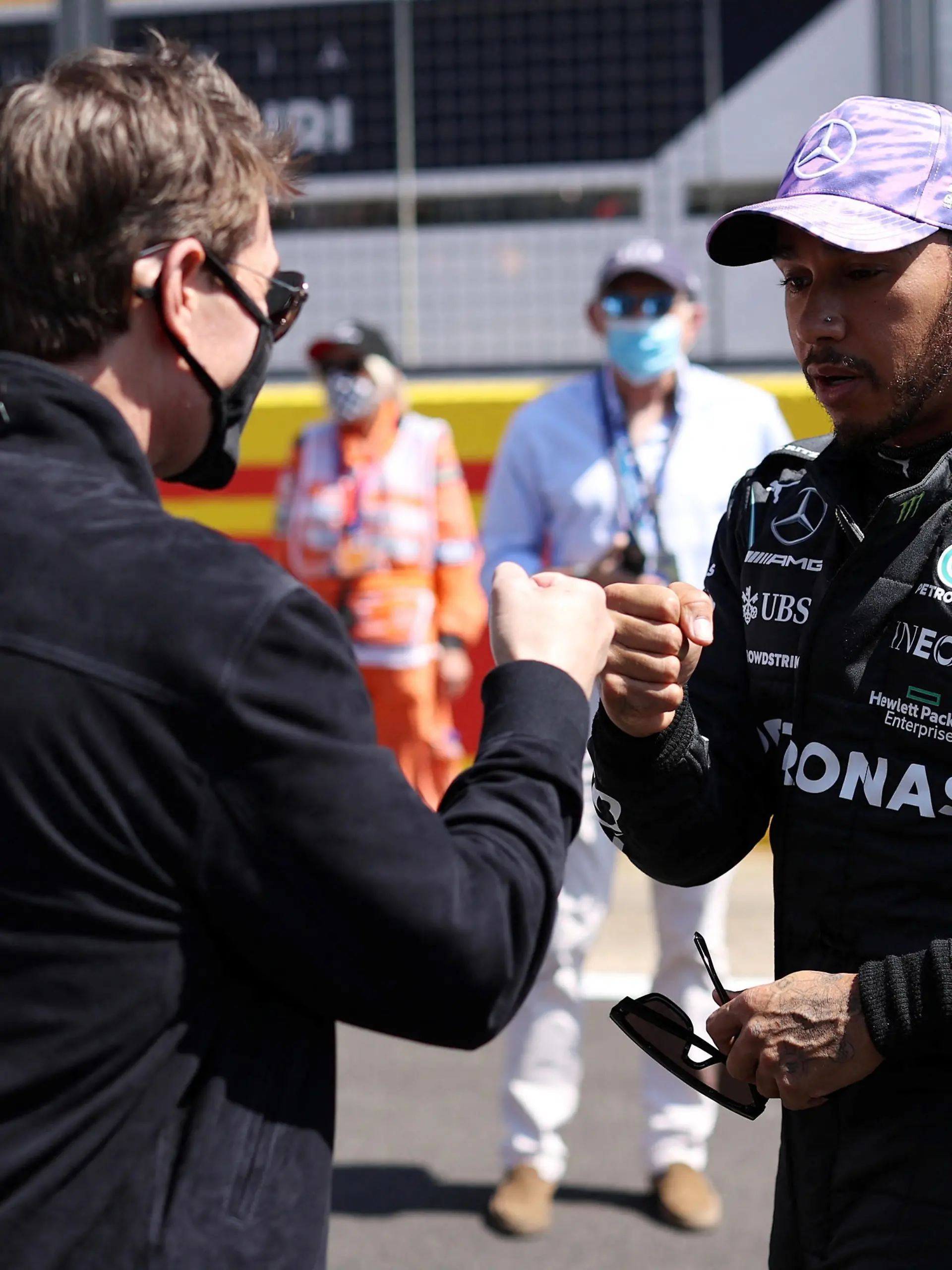 FILE PHOTO: Formula One F1 - British Grand Prix - Silverstone Circuit, Silverstone, Britain - July 18, 2021 Mercedes' Lewis Hamilton with Tom Cruise before the race Pool via REUTERS/Lars Baron/File Photo