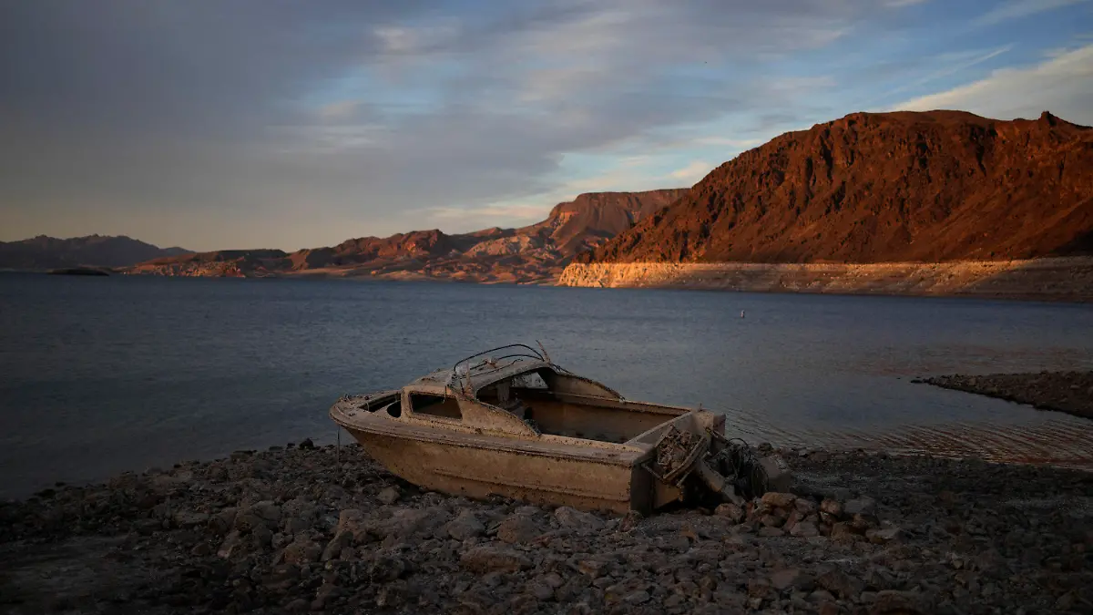 FILE - A formerly sunken boat sits high and dry along the shoreline of Lake Mead at the Lake Mead National Recreation Area, Tuesday, May 10, 2022, near Boulder City, Nev. Las Vegas area water officials want to cap the size of new swimming pools, citing worries about supplies from the drying-up Lake Mead reservoir on the drought-stricken Colorado River. (AP Photo/John Locher, File)