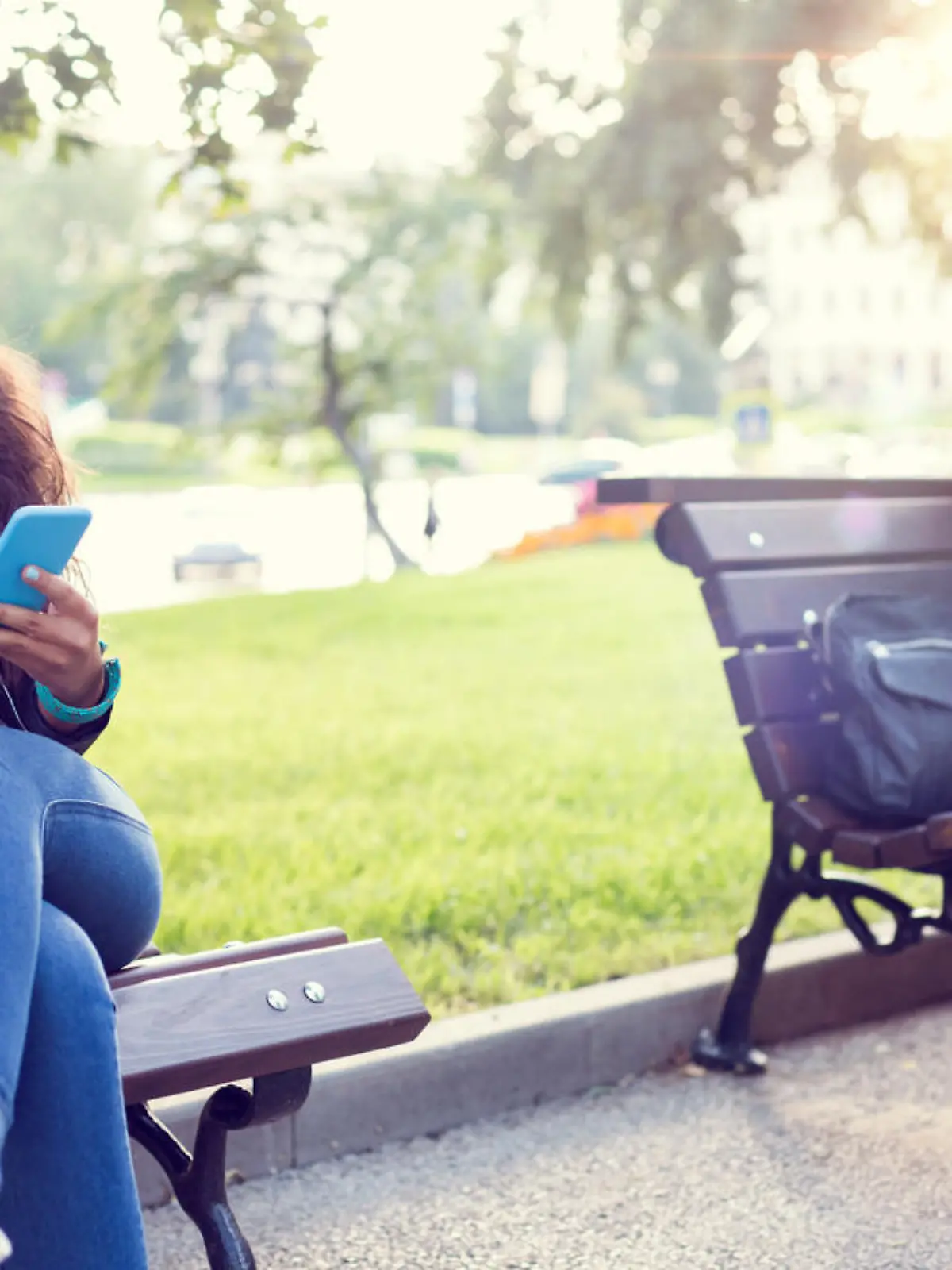 Happy couple using smartphones in the city park