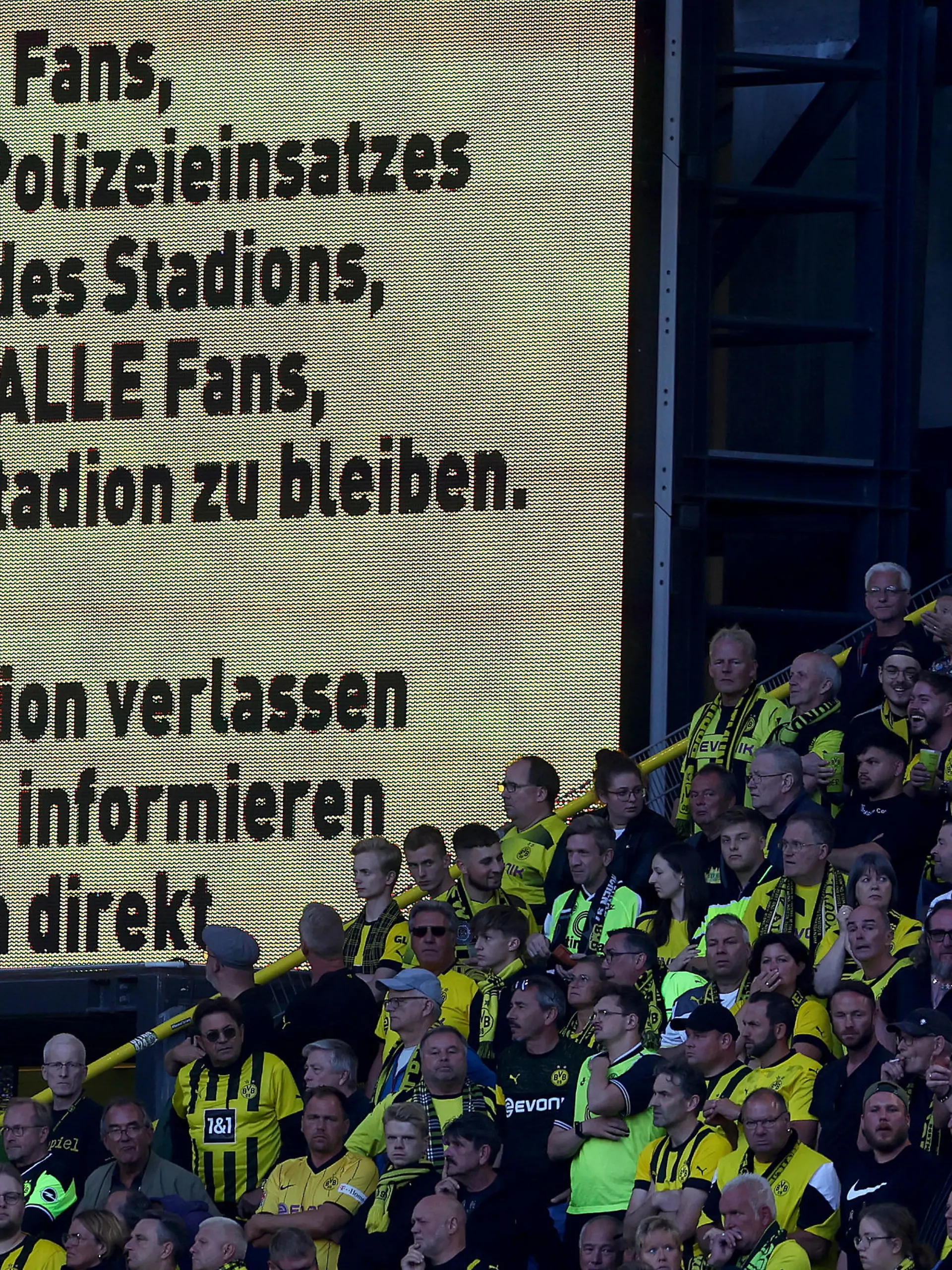 DORTMUND, GERMANY - AUGUST 06: A general view of the inside of the stadium as the LED Screen displays a message informing fans to remain inside the stadium after the final whistle due to a Police incident on the outside of the stadium during the Bundesliga match between Borussia Dortmund and Bayer 04 Leverkusen at Signal Iduna Park on August 06, 2022 in Dortmund, Germany. (Photo by Lars Baron/Getty Images)