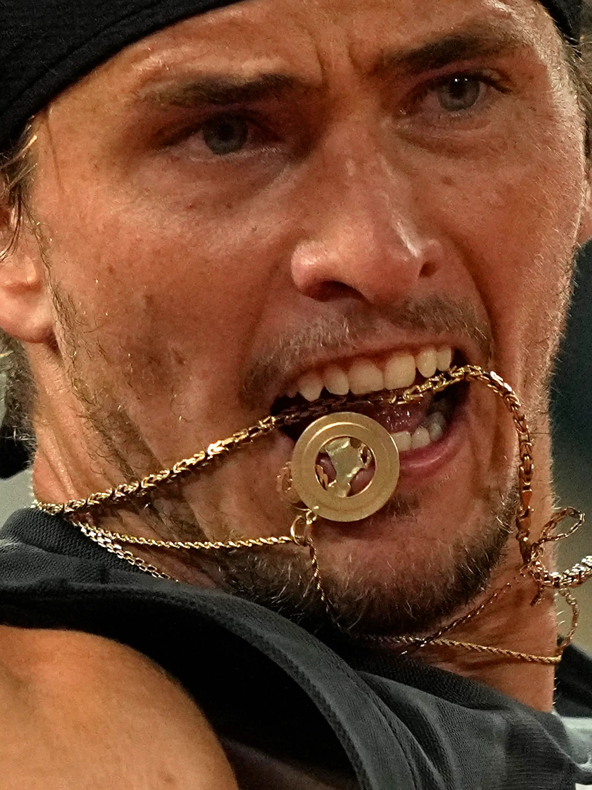 Germany's Alexander Zverev 's chain goes in his month as he plays Spain's Rafael Nadal during their semifinal match of the French Open tennis tournament at the Roland Garros stadium Friday, June 3, 2022 in Paris. (AP Photo/Michel Euler)