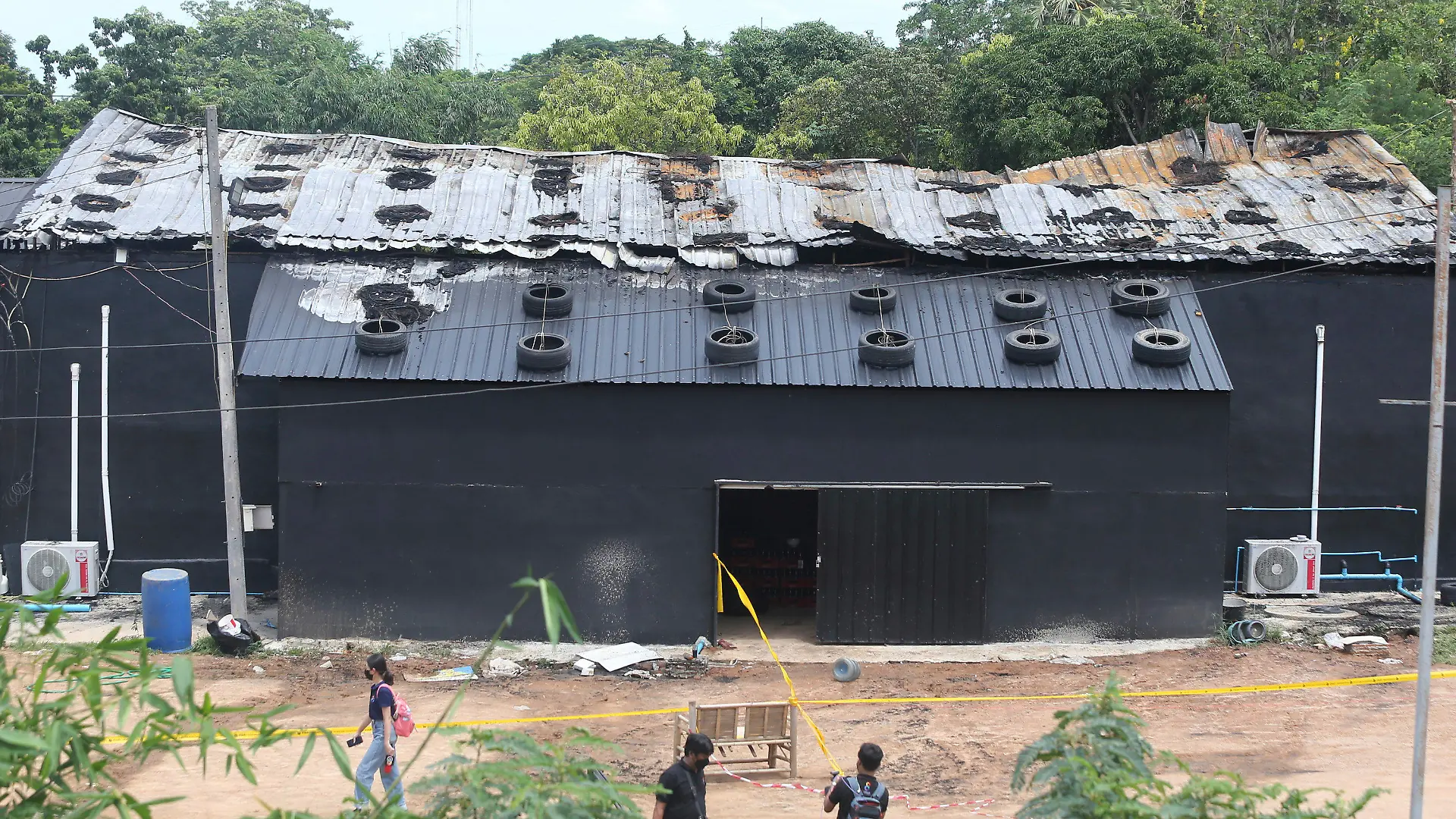 Exterior damage from a fire is seen at the Mountain B pub in the Sattahip district of Chonburi province, about 160 kilometers (100 miles) southeast of Bangkok. Over a dozen people were killed and dozens injured when a fire broke out early Friday morning at the crowded music pub, police and rescue workers said. (AP Photo/Anuthep Cheysakron)
