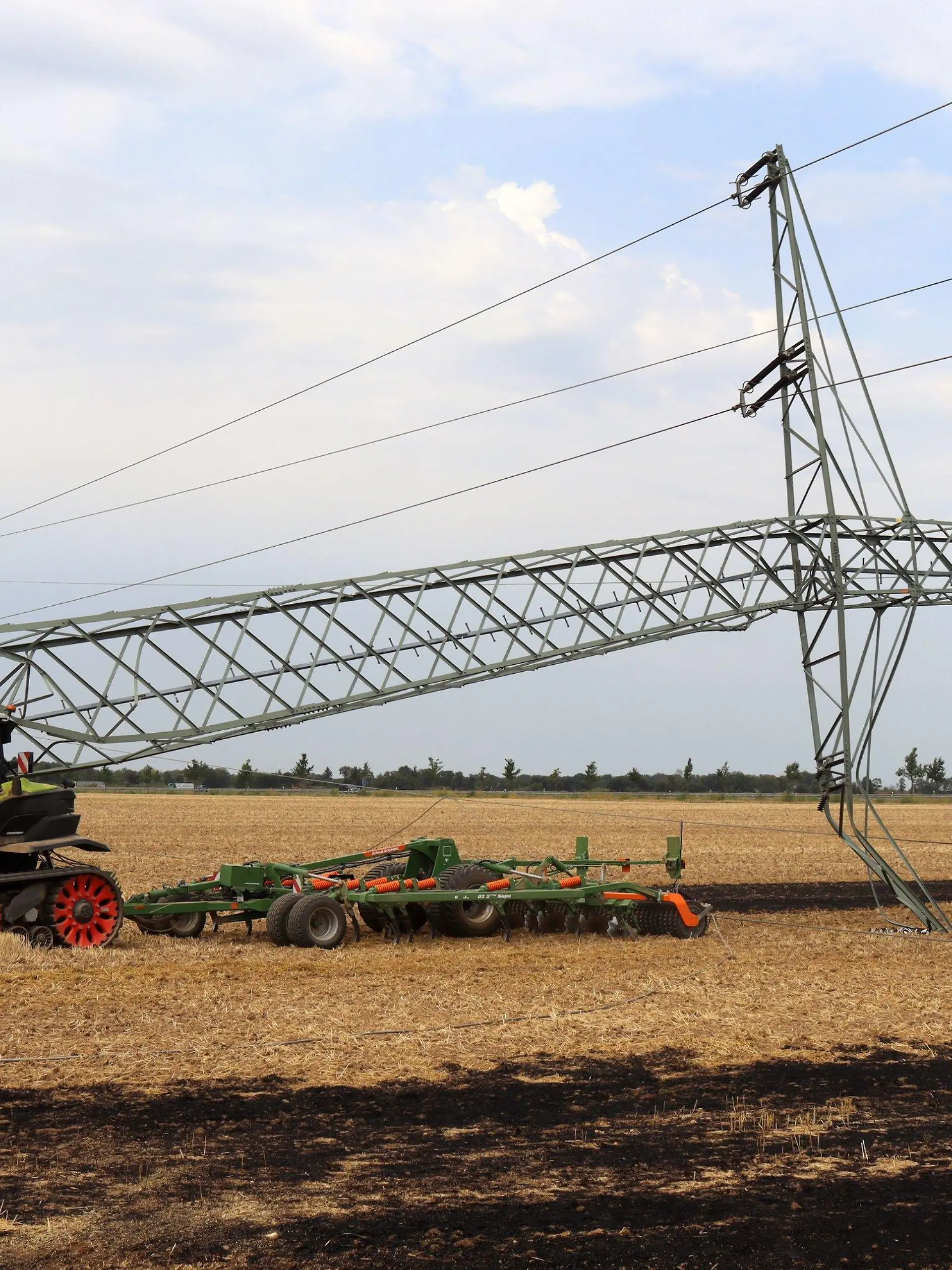 04.08.2022, Nordrhein-Westfalen, Weilerswist: Ein 16 Jahre alter Landwirt hat mit seinem Traktor den Mast einer Hochspannungsleitung umgeknickt und so einen großflächigen Stromausfall mit Zehntausenden Betroffenen verursacht. Teile der Kreise Euskirchen und Düren sowie des Rhein-Erft- und Rhein-Sieg-Kreises seien ohne Strom, sagte eine Sprecherin des Verteilnetzbetreibers Westnetz am Donnerstag. (zu dpa «16-jähriger Bauer fährt mit Traktor Mast um - Zehntausende ohne Strom») Foto: Thomas Schmitz/Kölner Stadt-Anzeiger Medien/dpa +++ dpa-Bildfunk +++