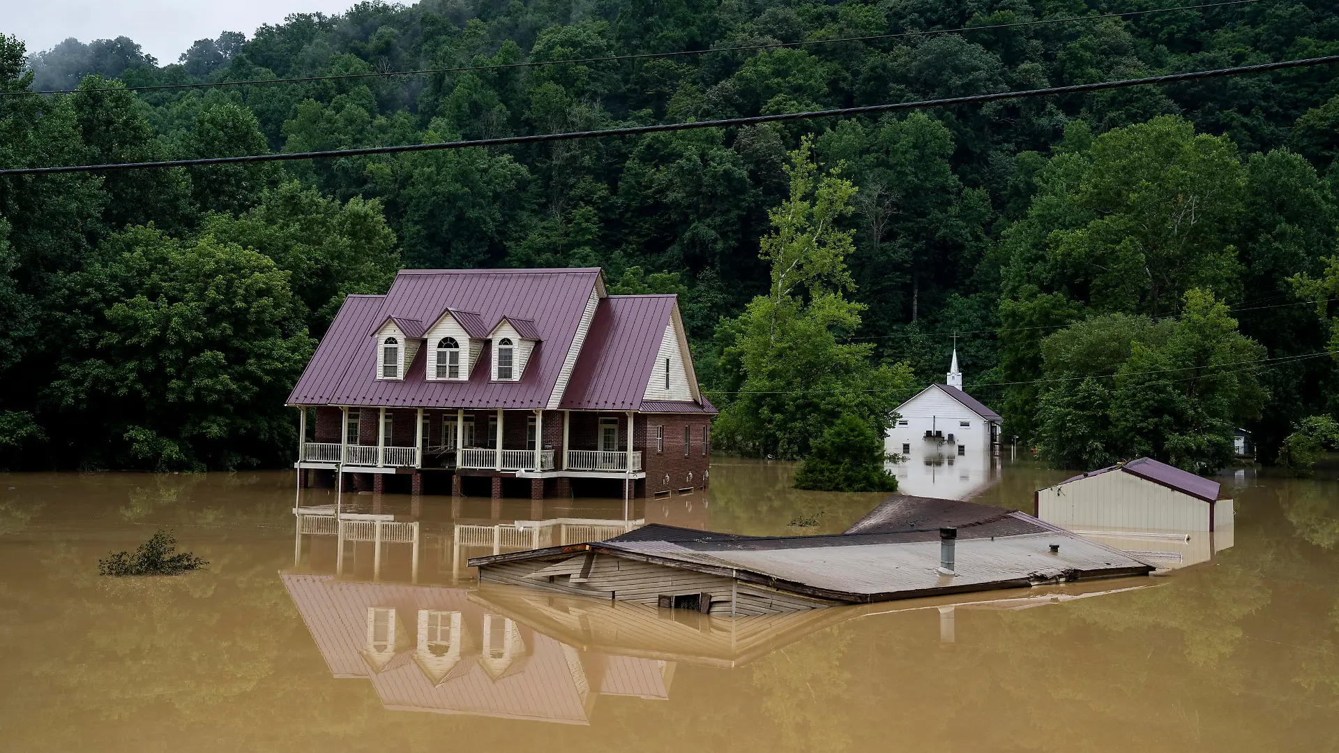 JACKSON, KY - JULY 29:  A house is seen almost completely submerged off of the Bert T Combs Mountain Parkway on July 29, 2022 in Breathitt County, Kentucky. At least 16 people have been killed and hundreds had to be rescued amid flooding from heavy rainfall. 
 (Photo by Michael Swensen/Getty Images)