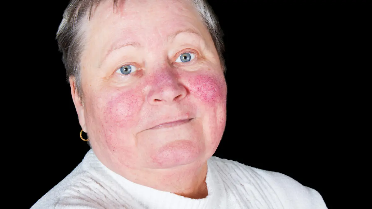 Portrait of happy and smiling senior woman in photo studio isolated on black background