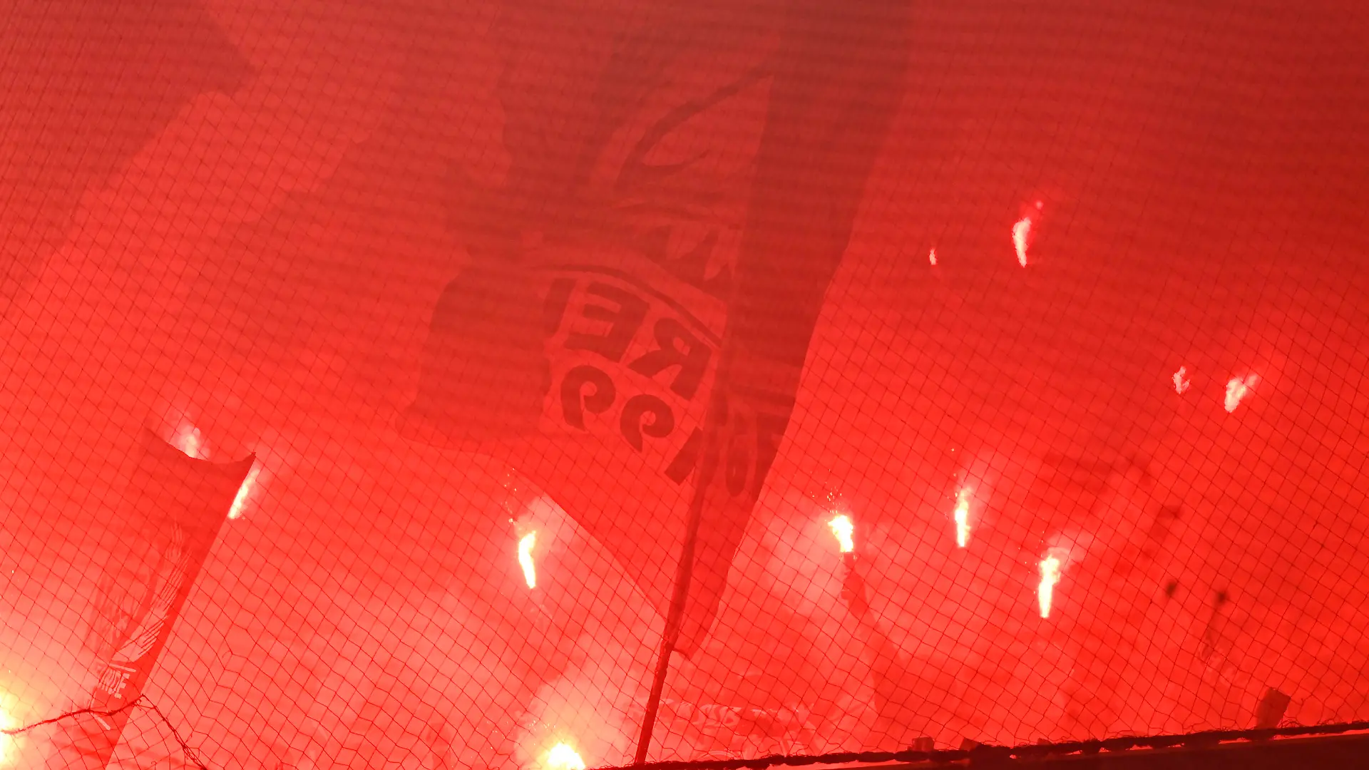 Soccer Football - DFB Cup - First Round - FC Magdeburg v Eintracht Frankfurt - MDCC-Arena, Magdeburg, Germany - August 1, 2022 Eintracht Frankfurt fans with flares REUTERS/Fabian Bimmer DFB REGULATIONS PROHIBIT ANY USE OF PHOTOGRAPHS AS IMAGE SEQUENCES AND/OR QUASI-VIDEO.