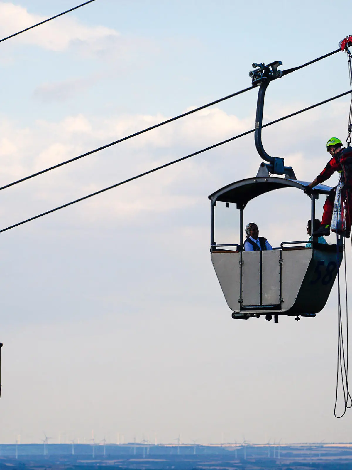 dpatopbilder - 29.07.2022, Hessen, Rüdesheim am Rhein: Höhenretter sind an einer stehengebliebenen Seilbahn an einer Gondel mit Passagieren im Einsatz. Rettungskräfte haben am Freitagabend 41 Menschen aus den Gondeln der Seilbahn Rüdesheim in Hessen befreit. Die knapp 1,4 Kilometer lange Bahn war zuvor wegen eines technischen Defekts an der Hydraulik stehengeblieben, wie ein Polizeisprecher sagte. Die Fahrgäste waren fast drei Stunden lang in den bis zu 14 Meter über der Erde hängenden Gondeln gefangen. Insgesamt wurden 41 Passagiere aus 20 Gondeln gerettet. Verletzt wurde bei dem Vorfall niemand. Foto: -/5vision.Media/dpa +++ dpa-Bildfunk +++