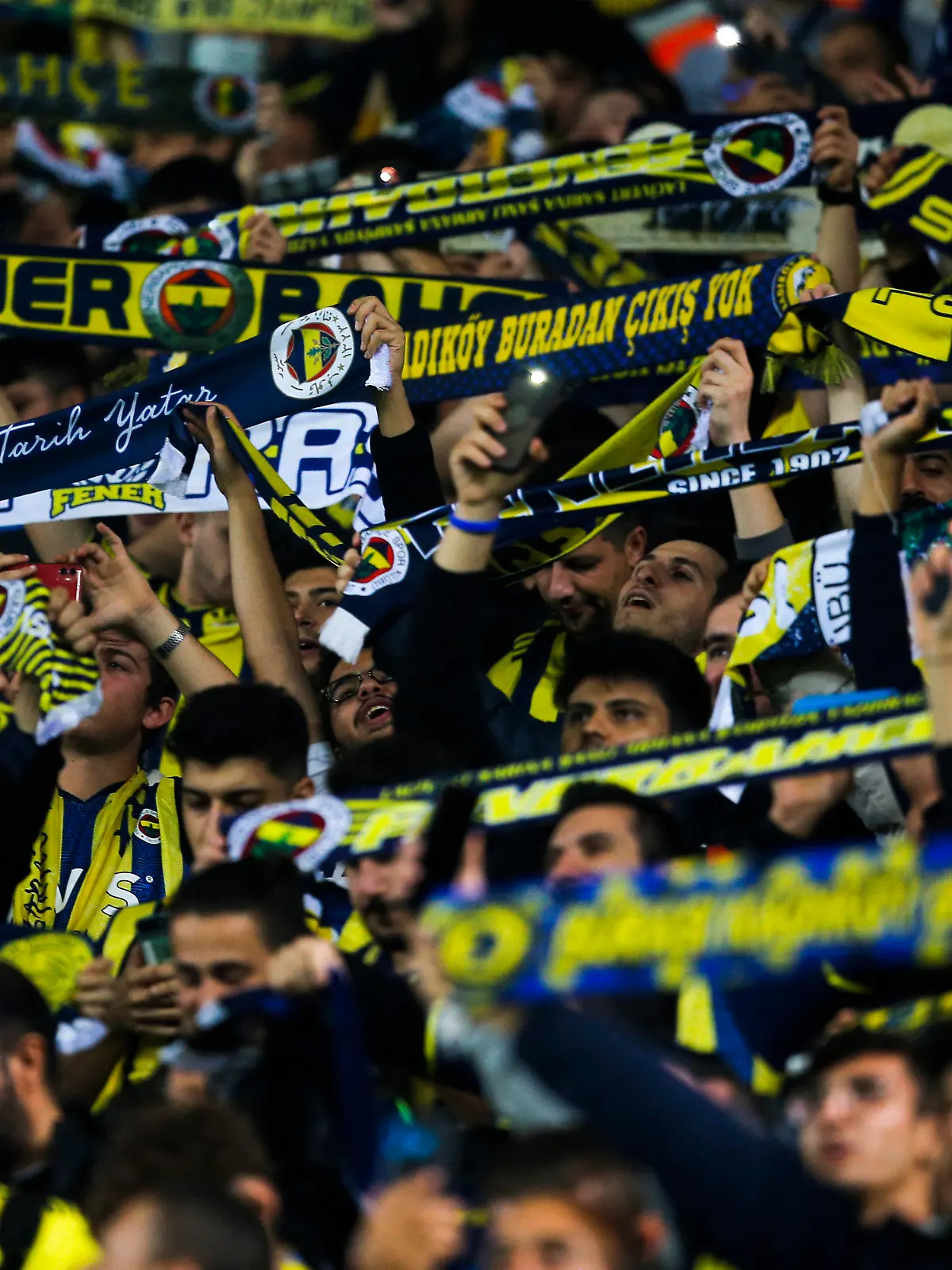 FILE - Fenerbahce fans cheer prior the Europa League group D soccer match between Fenerbahce and Antwerp at the Sukru Saracoglu stadium in Istanbul, Turkey, on Oct. 21, 2021. UEFA is investigating Turkish club Fenerbahçe after its fans chanted the name of Russian President Vladimir Putin during a Champions League qualifying game against Ukraine’s Dynamo Kyiv. The chants were heard at Fenerbahçe’s stadium in Istanbul shortly after Vitaliy Buyalskiy scored the opening goal for Dynamo in a game the Ukrainian team went on to win 2-1 after extra time on Wednesday. (AP Photo, File)