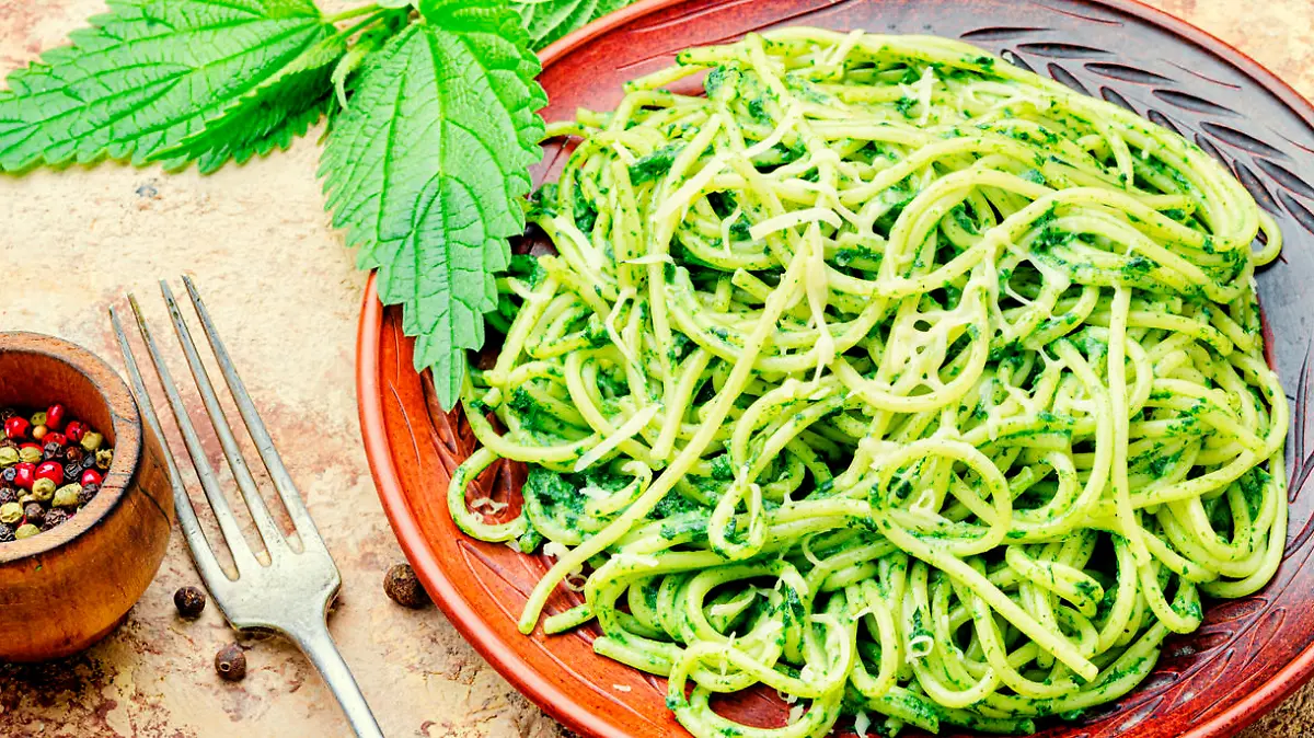 Italian traditional pasta with green nettle sauce.