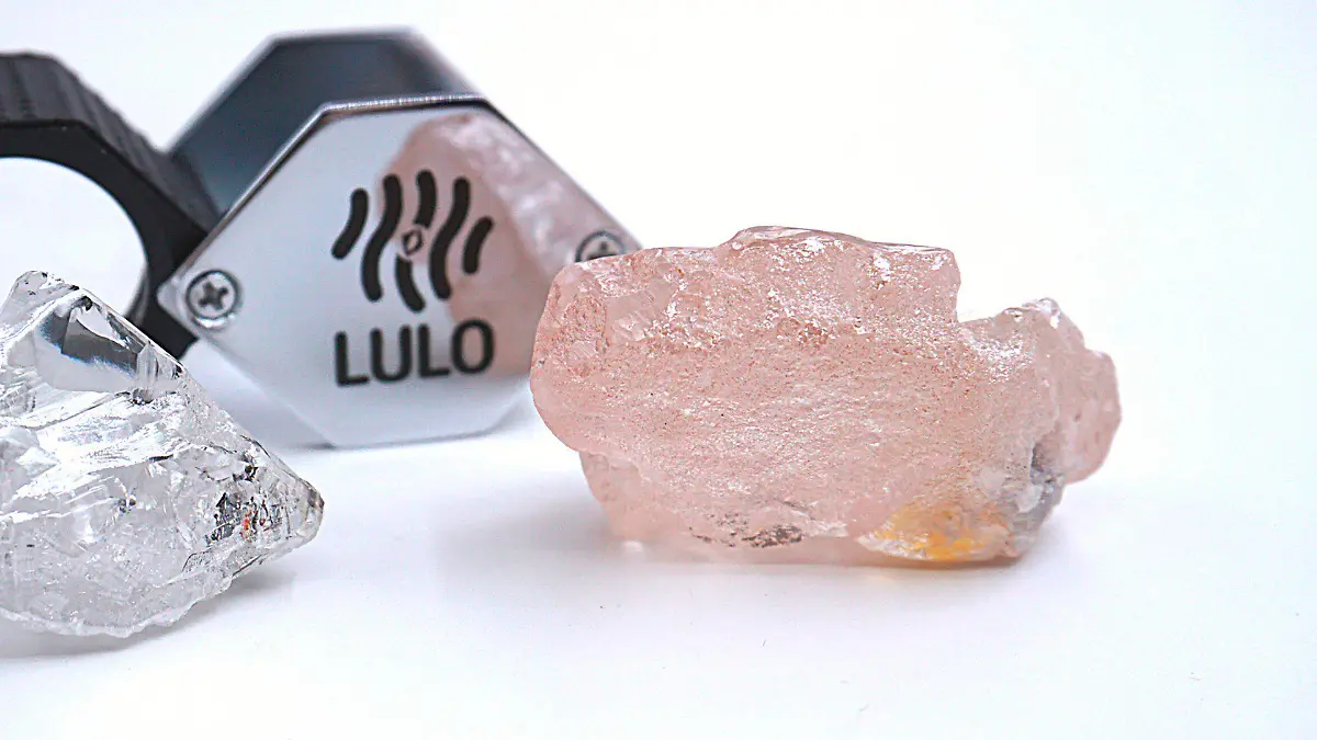 This photo supplied by Lucapa Diamond Company on Wednesday, July 27, 2022, shows the 170 carat pink diamond, right, recovered from Lulo, Angola. A big pink diamond of 170 carats has been discovered in Angola and is claimed to be the largest such gemstone found in 300 years. Called the “Lulo Rose,” the diamond was found at the Lulo alluvial diamond mine. The mine’s owner, the Lucapa Diamond Company, on Wednesday announced the discovery of the large pink diamond on its website. (Lucapa Diamond Company via AP)