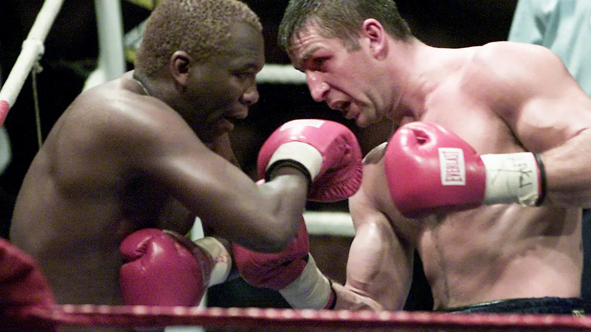 FILE — Defending champion Eric Lucas, right, serves an uppercut to South Africa's Dingaan Thobela, left, during the WBC super middleweight championship on Nov. 30, 2001 in Montreal, Canada. Thobela, a two-weight world champion known as "The Rose of Soweto," has died. He was 57. (AP Photo/Paul Chiasson, File)
