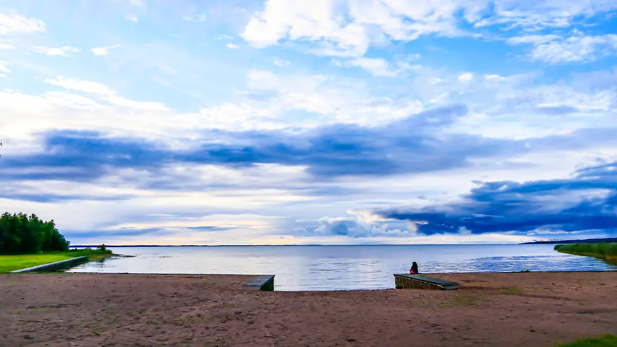 Lidkoping, Sweden A beach and person at the Filsback beach on Lake Vanern.