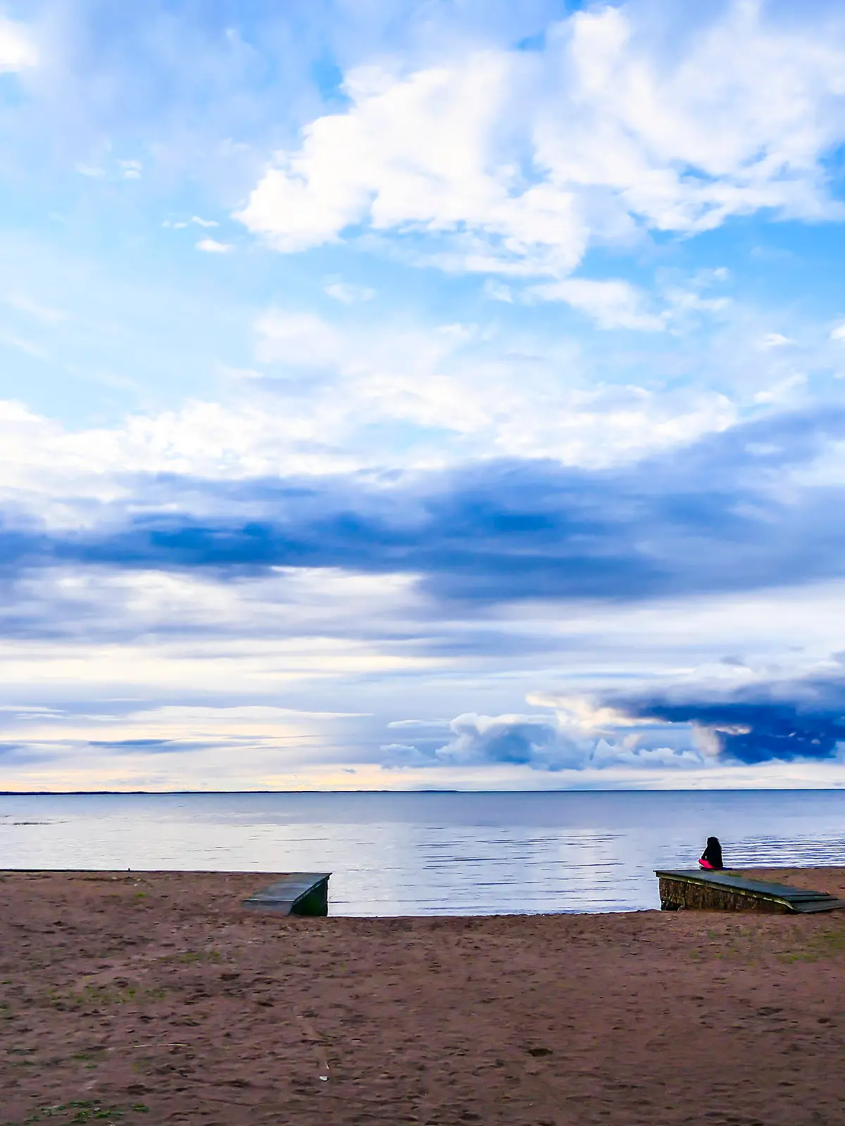 Lidkoping, Sweden A beach and person at the Filsback beach on Lake Vanern.