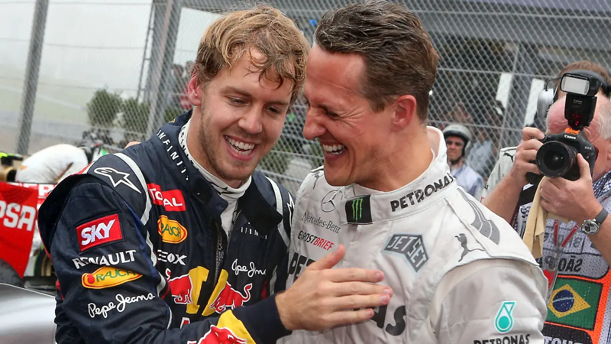 ARCHIV - 25.11.2012, Brasilien, São Paulo: Der deutsche Formel-1-Fahrer Sebastian Vettel (l) feiert mit Michael Schumacher im Autodromo Jose Carlos Pace seinen dritten Weltmeistertitel in Folge. Sebastian Vettel wird keinen neuen Vertrag bei Aston Martin unterschreiben und seine Formel-1-Karriere nach dieser Saison beenden. Das teilte der 35 Jahre alte viermalige Weltmeister am Donnerstag in Budapest mit. (zu dpa «Formel 1: Rücktritt von Sebastian Vettel nach dieser Saison») Foto: Jens Büttner/dpa +++ dpa-Bildfunk +++