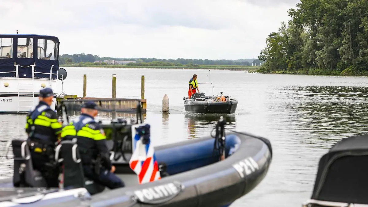 22.07.2022, Niederlande, Biddinghuizen: Polizisten und andere Rettungskräfte sind im Einsatz, um eine Leiche zu bergen, nachdem eine deutsche Familie beim Kanufahren auf dem Veluwemeer verunglückt ist. Foto: News United/ANP/dpa +++ dpa-Bildfunk +++