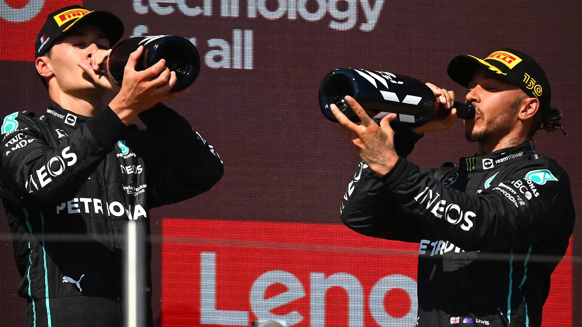 LE CASTELLET, FRANCE - JULY 24: Second placed Lewis Hamilton of Great Britain and Mercedes and Third placed George Russell of Great Britain and Mercedes celebrate on the podium during the F1 Grand Prix of France at Circuit Paul Ricard on July 24, 2022 in Le Castellet, France. (Photo by Dan Mullan/Getty Images)