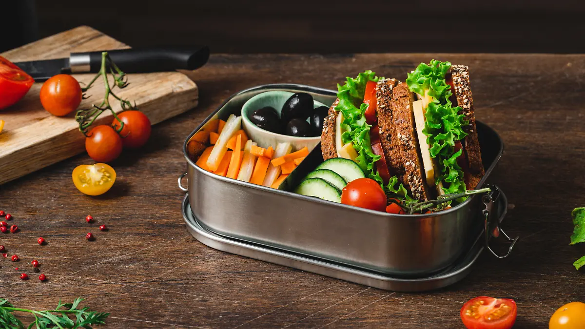 Closeup of a lunch box with healthy meal. Fruits, vegetables and healthy sandwich in the lunch box.