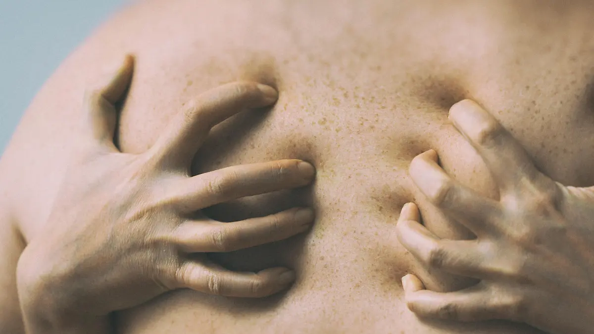 Couple in passion. Female hands on male back.