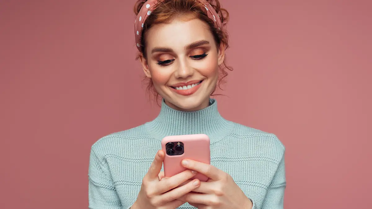 Close-up portrait of a young pretty girl using smart phone