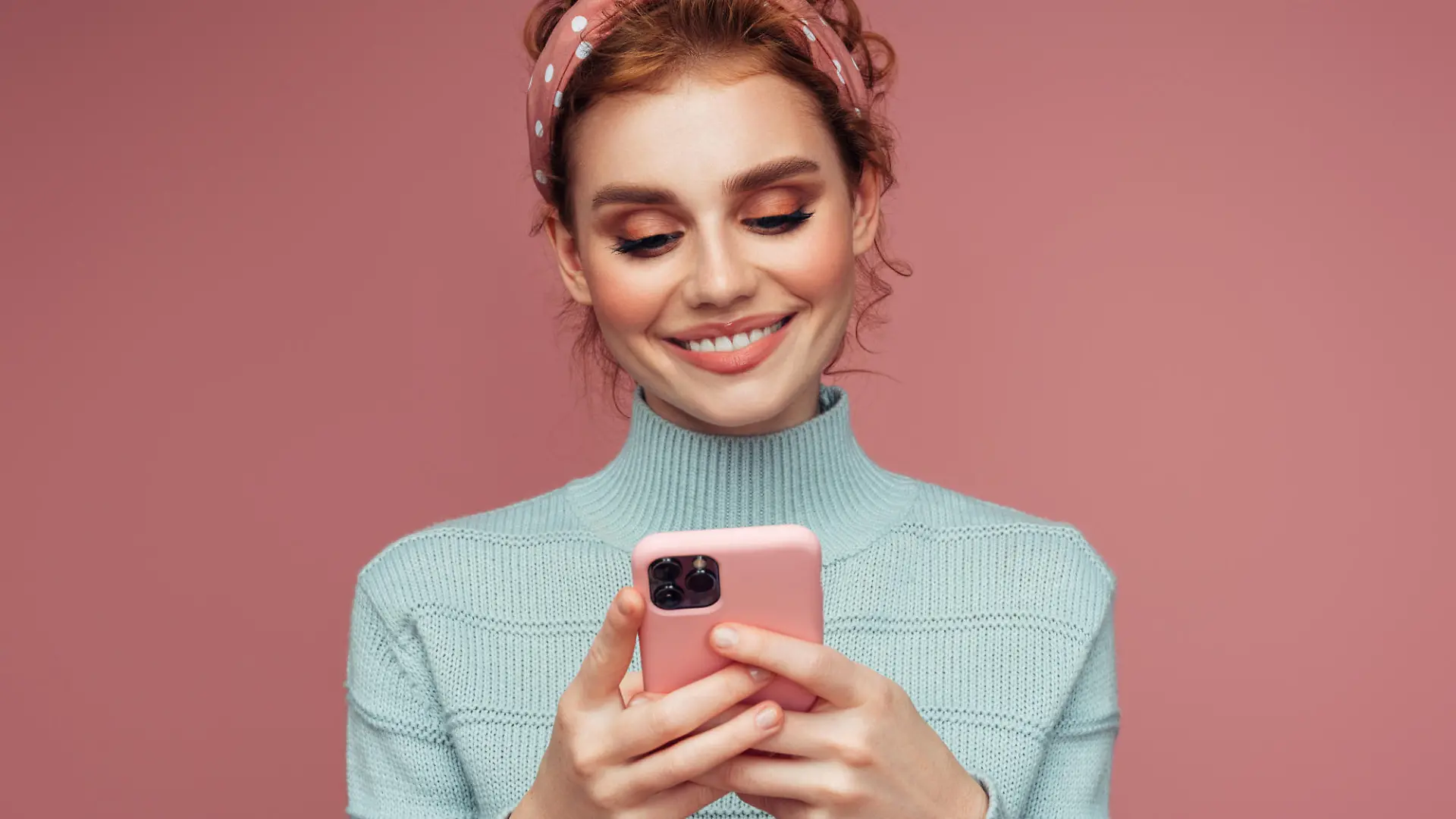 Close-up portrait of a young pretty girl using smart phone