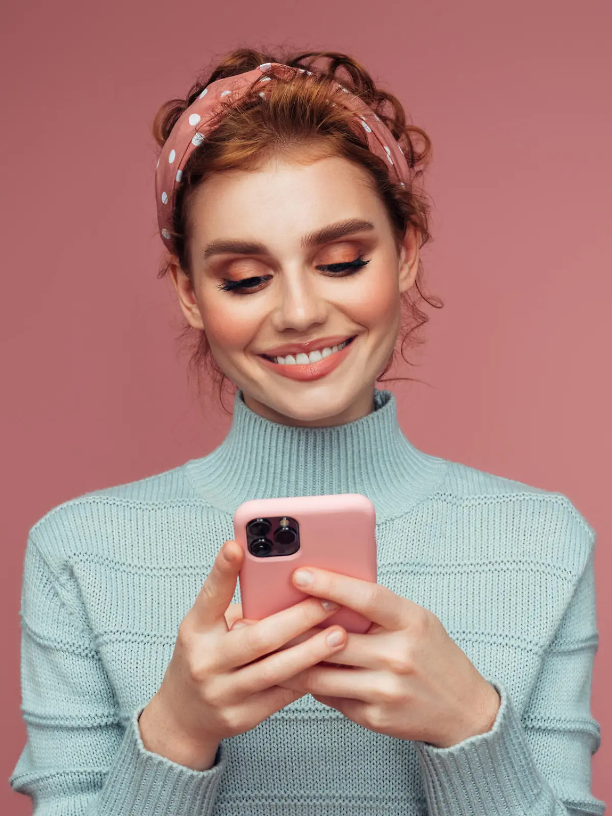 Close-up portrait of a young pretty girl using smart phone