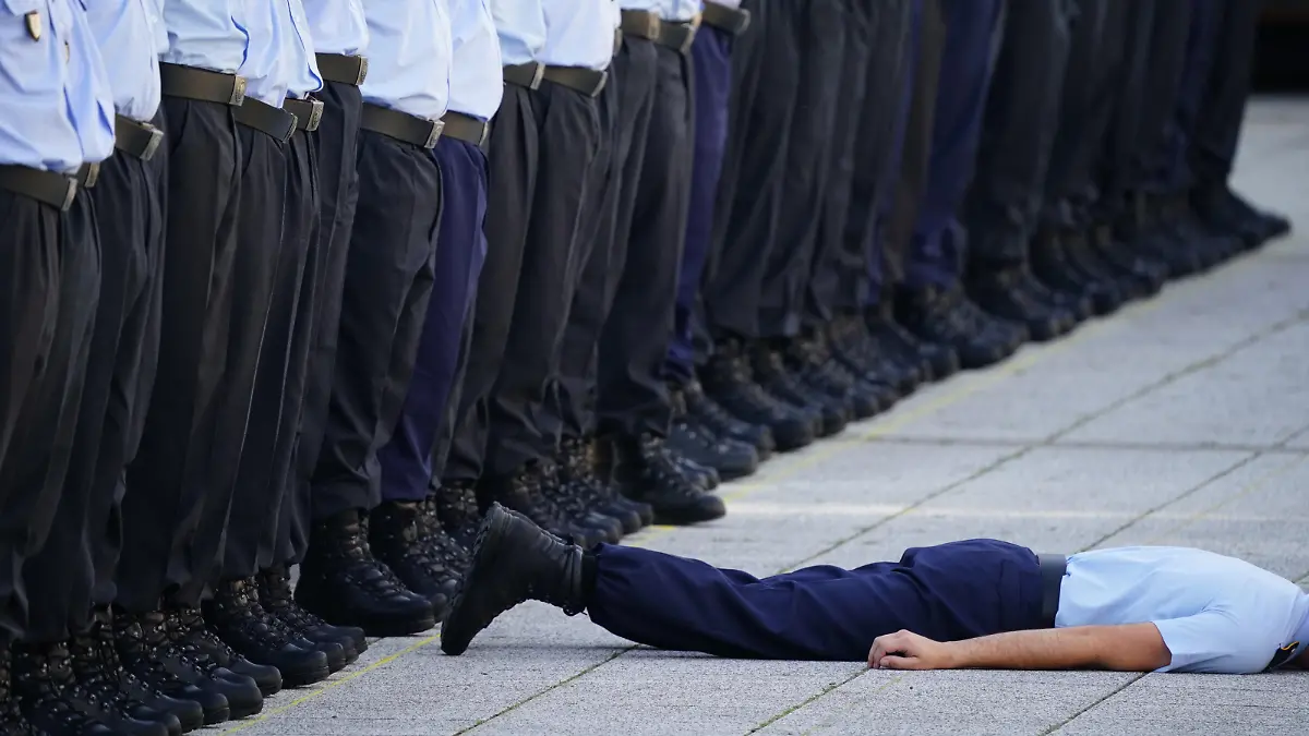 epa10082652 A recruit lies on the ground after falling during an official oath-taking ceremony of the German Armed Forces at the defense ministry (Bendlerblock) in Berlin, Germany, 20 July 2022. Sweltering temperatures hit much of western Europe in mid-July 2022. The ceremony is held 78 years after the failed attempt by Claus von Stauffenberg and other conspirators to assassinate the Nazi dictator Adolf Hitler on 20 July 1944. They were arrested and executed at the Bendlerblock after the failed assassination attempt. EPA-EFE/CLEMENS BILAN