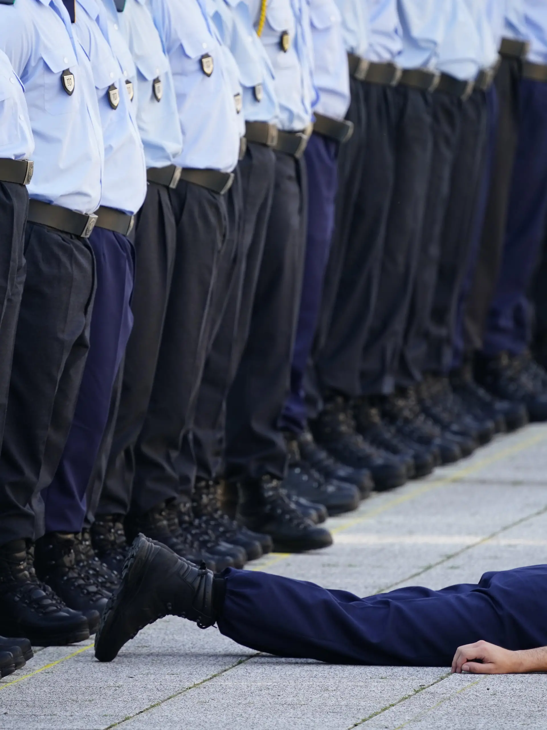 epa10082652 A recruit lies on the ground after falling during an official oath-taking ceremony of the German Armed Forces at the defense ministry (Bendlerblock) in Berlin, Germany, 20 July 2022. Sweltering temperatures hit much of western Europe in mid-July 2022. The ceremony is held 78 years after the failed attempt by Claus von Stauffenberg and other conspirators to assassinate the Nazi dictator Adolf Hitler on 20 July 1944. They were arrested and executed at the Bendlerblock after the failed assassination attempt.  EPA-EFE/CLEMENS BILAN