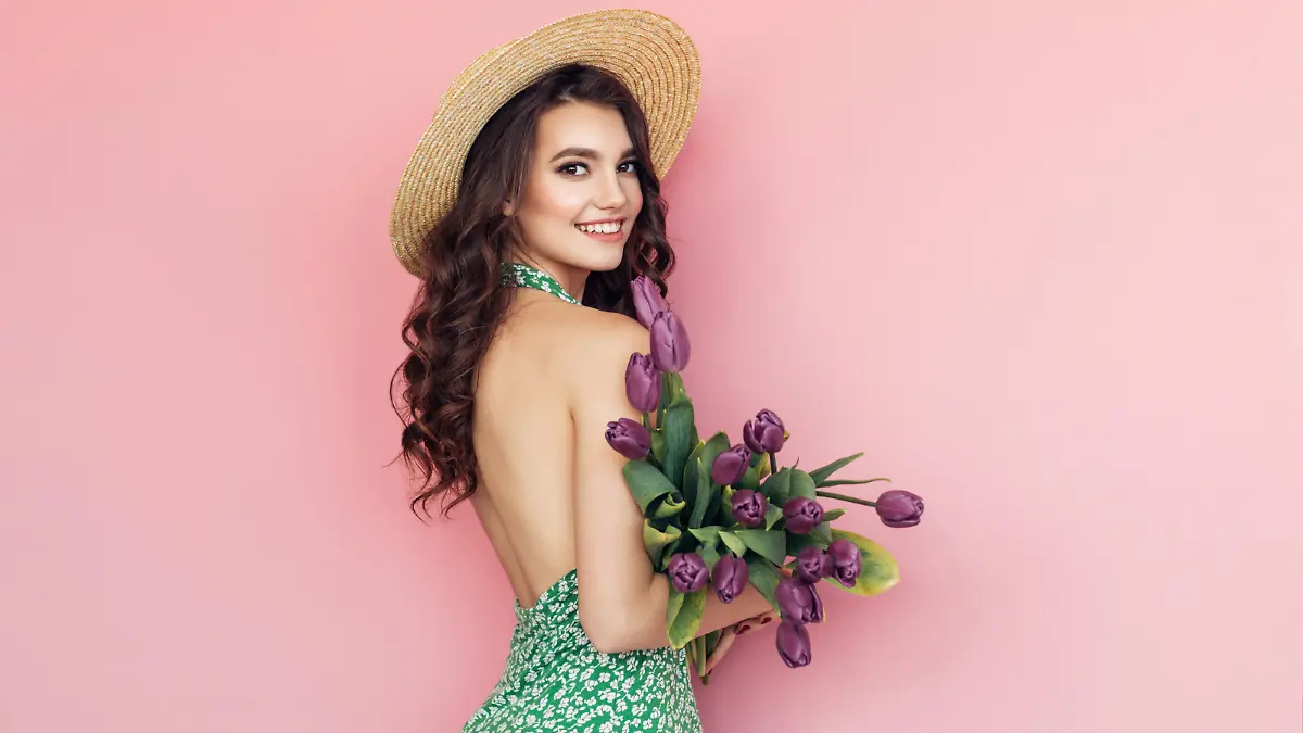 Lovely woman with purple tulips bunch
