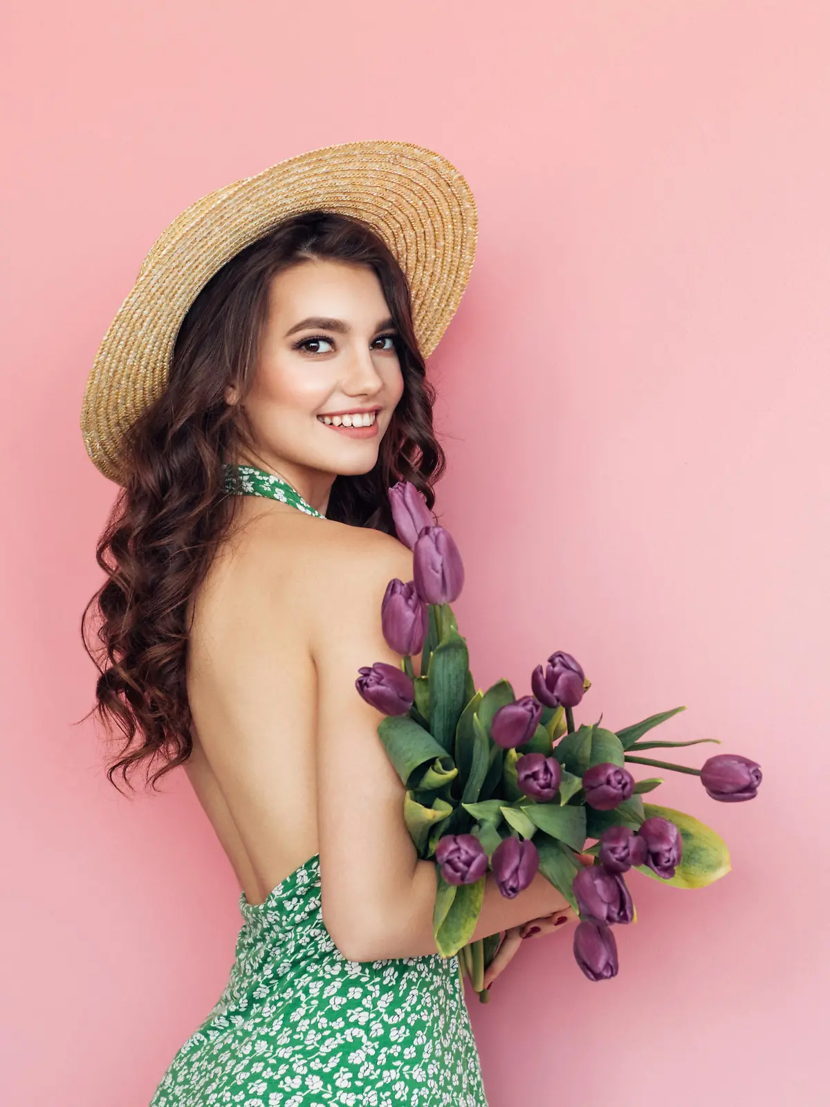 Lovely woman with purple tulips bunch