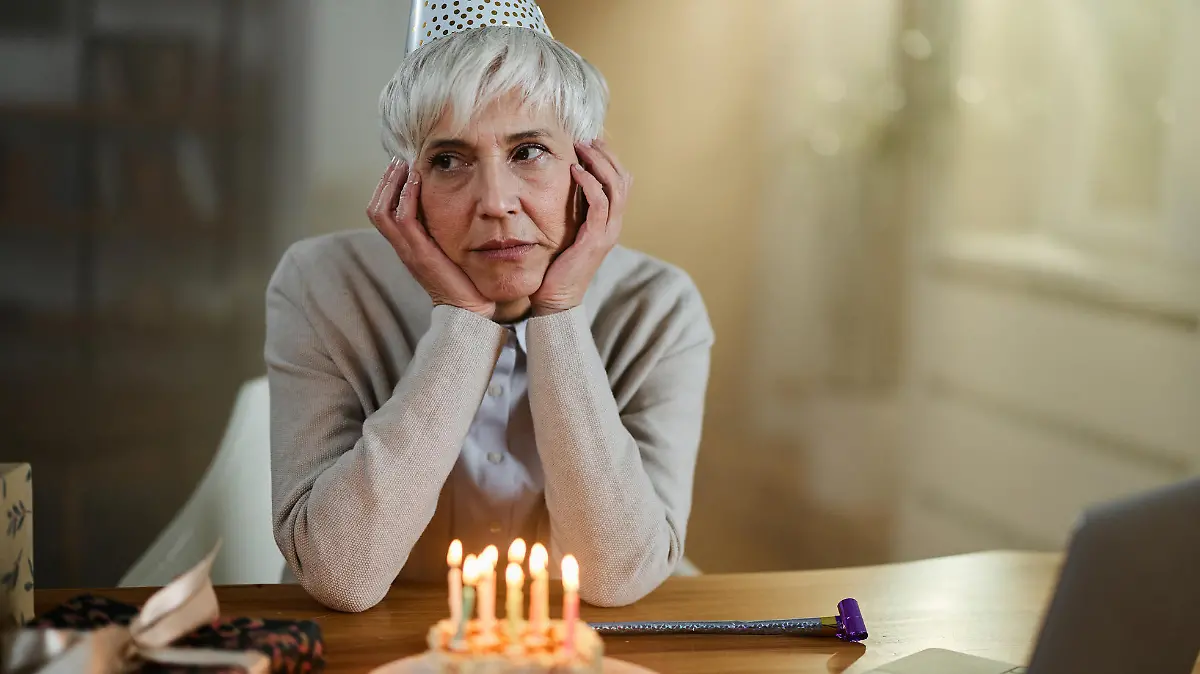 Depressed senior woman feeling lonely on her Birthday at home.