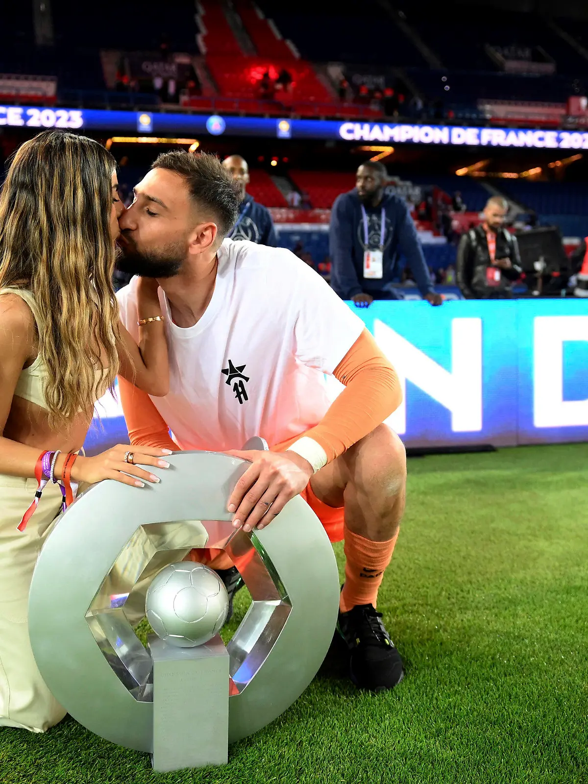 FILE - Paris Saint-Germain's Italian goalkeeper Gianluigi Donnarumma kisses his partner as they pose with the trophy following the team's French League One soccer match loss to Clermont, in Paris, Saturday, June 3, 2023. French police are investigating a violent armed robbery that targeted Paris Saint-Germain goalkeeper Gianluigi Donnarumma at his home. The Paris prosecutor's office said Friday July 21, 2023 the player was targeted overnight Thursday to Friday. (Franck Fife/Pool Photo via AP, File)