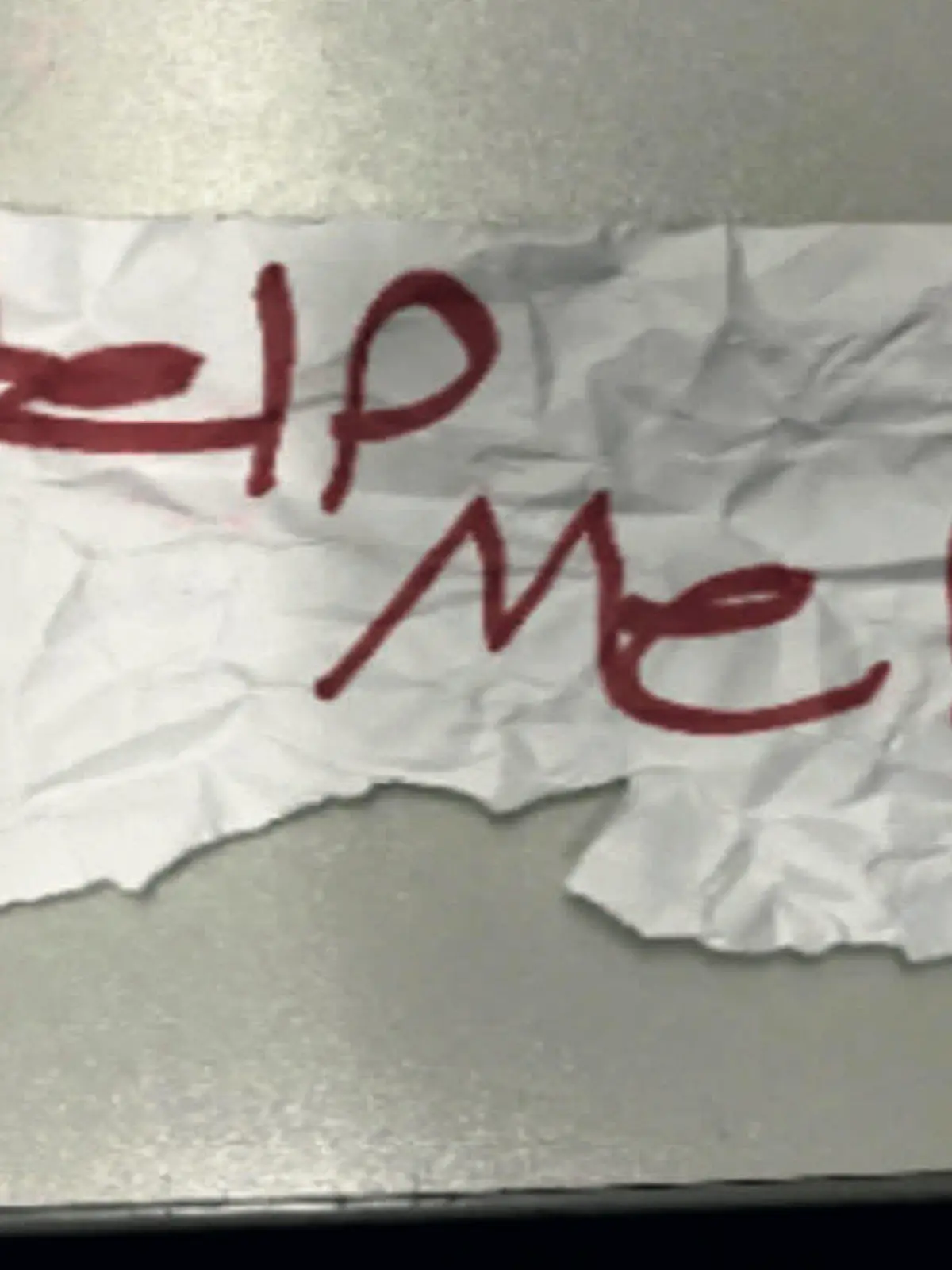 In this undated photo released by the U.S Department of Justice is a "Help Me!" sign used by a 13-year-old girl kidnapped in Texas. The girl was rescued in Southern California on July 9, 2023, when passersby saw her hold up the sign in a parked car, police said. The rescue occurred in Long Beach when officers responded to a trouble call and found the "visibly emotional and distressed girl," police said in a press release Thursday, July 20.  (U.S. Department of Justice via AP)