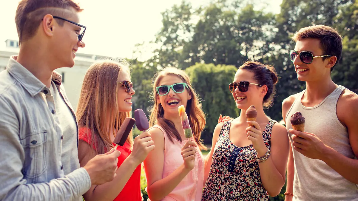 friendship, leisure, sweets, summer and people concept - group of smiling friends with ice cream outdoors